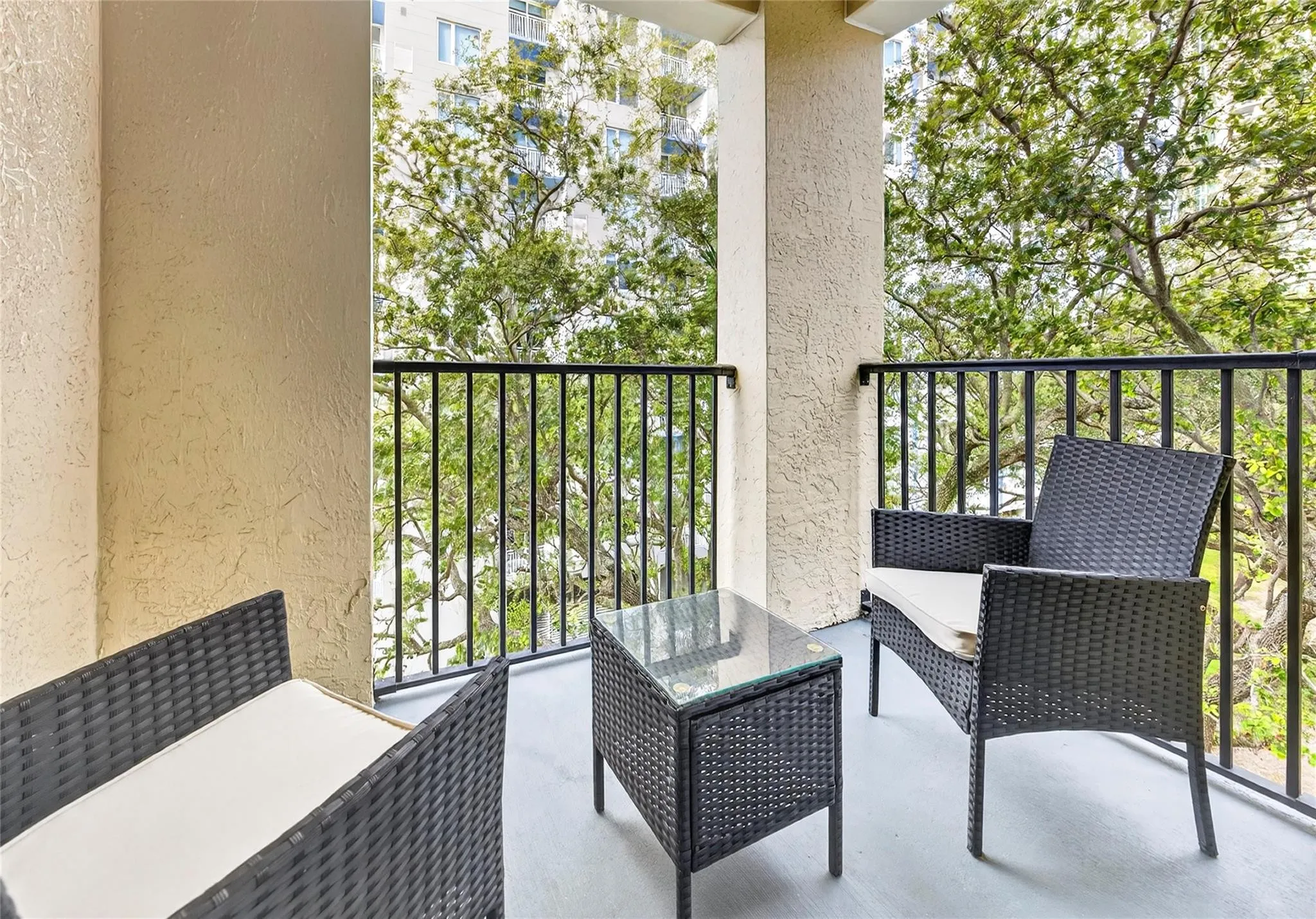 Private primary patio offers a peaceful retreat with leafy treetop views—perfect for morning coffee or unwinding in the evening.