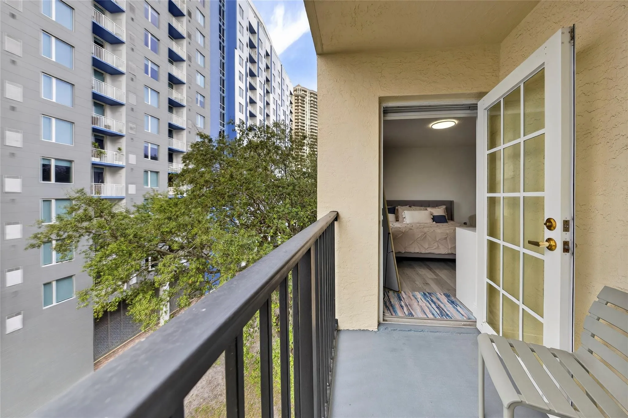 Private patio off the primary bedroom offers treetop views and a quiet outdoor space to relax and unwind.
