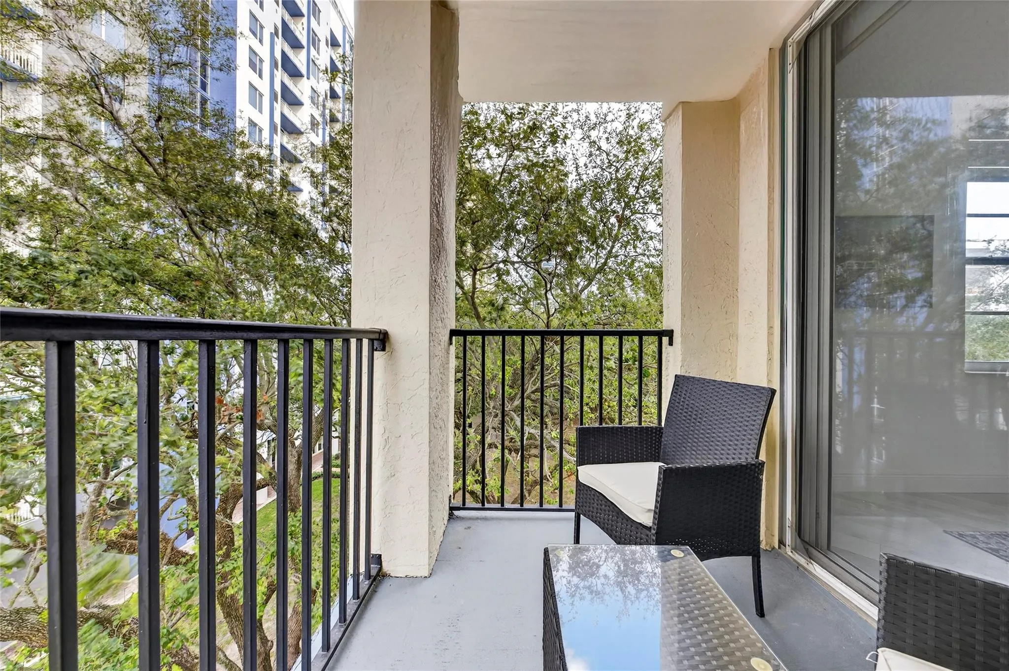 Private primary patio offers a peaceful retreat with leafy treetop views—perfect for morning coffee or unwinding in the evening.