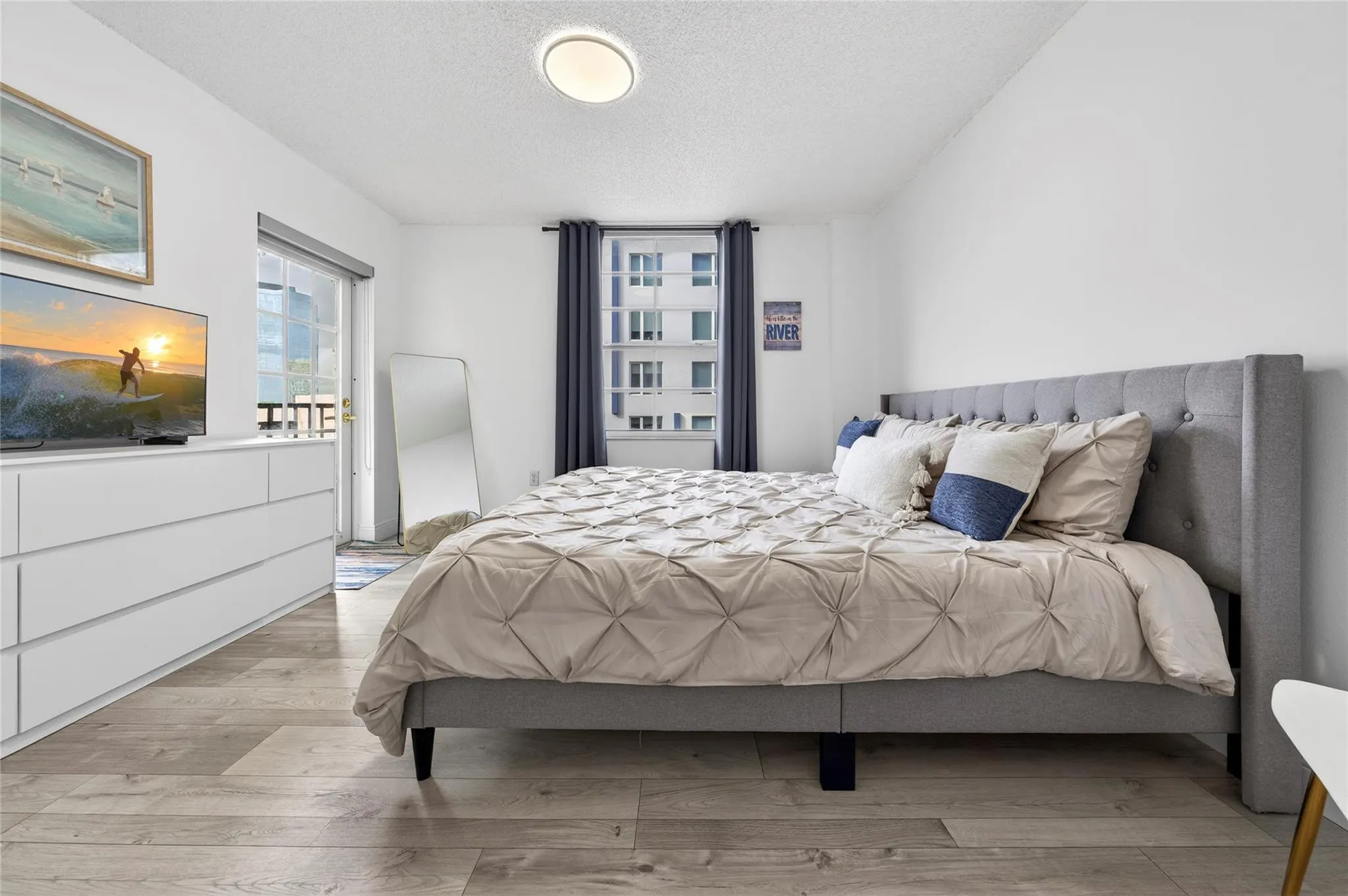 Spacious primary suite features a private patio and a recently remodeled en-suite bathroom, creating a peaceful and comfortable retreat.