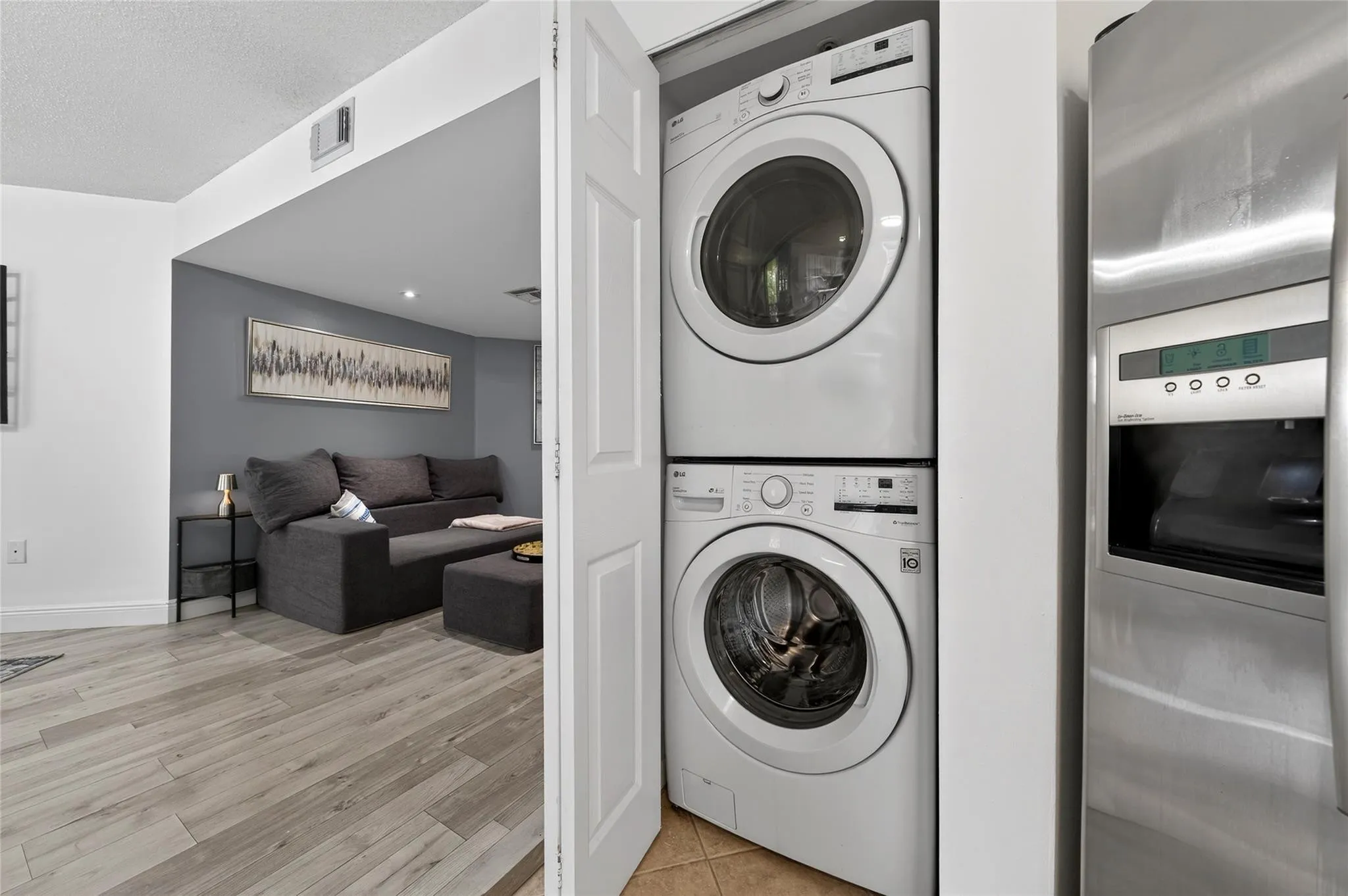 Convenient in-unit laundry with stacked washer and dryer discreetly tucked away, offering everyday ease without sacrificing living space.