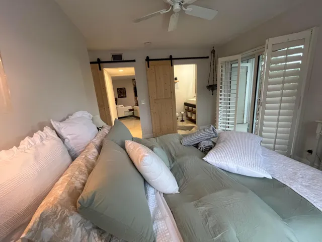 Large main bedroom with sliding doors out to screen patio