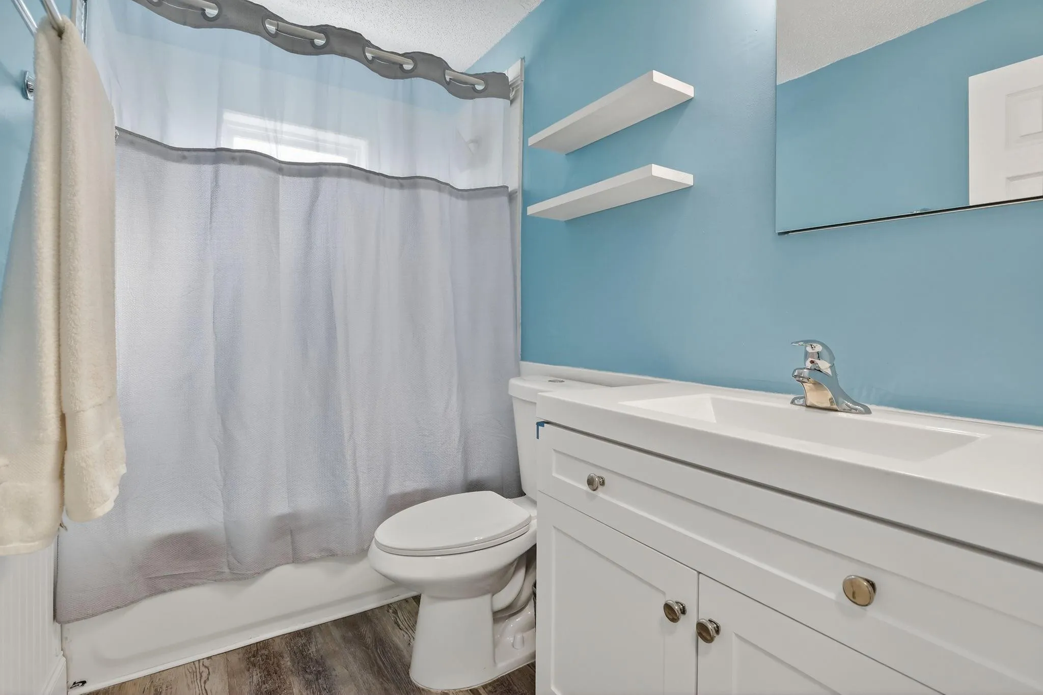 Updated bathroom with NEW vanity and shower fixtures