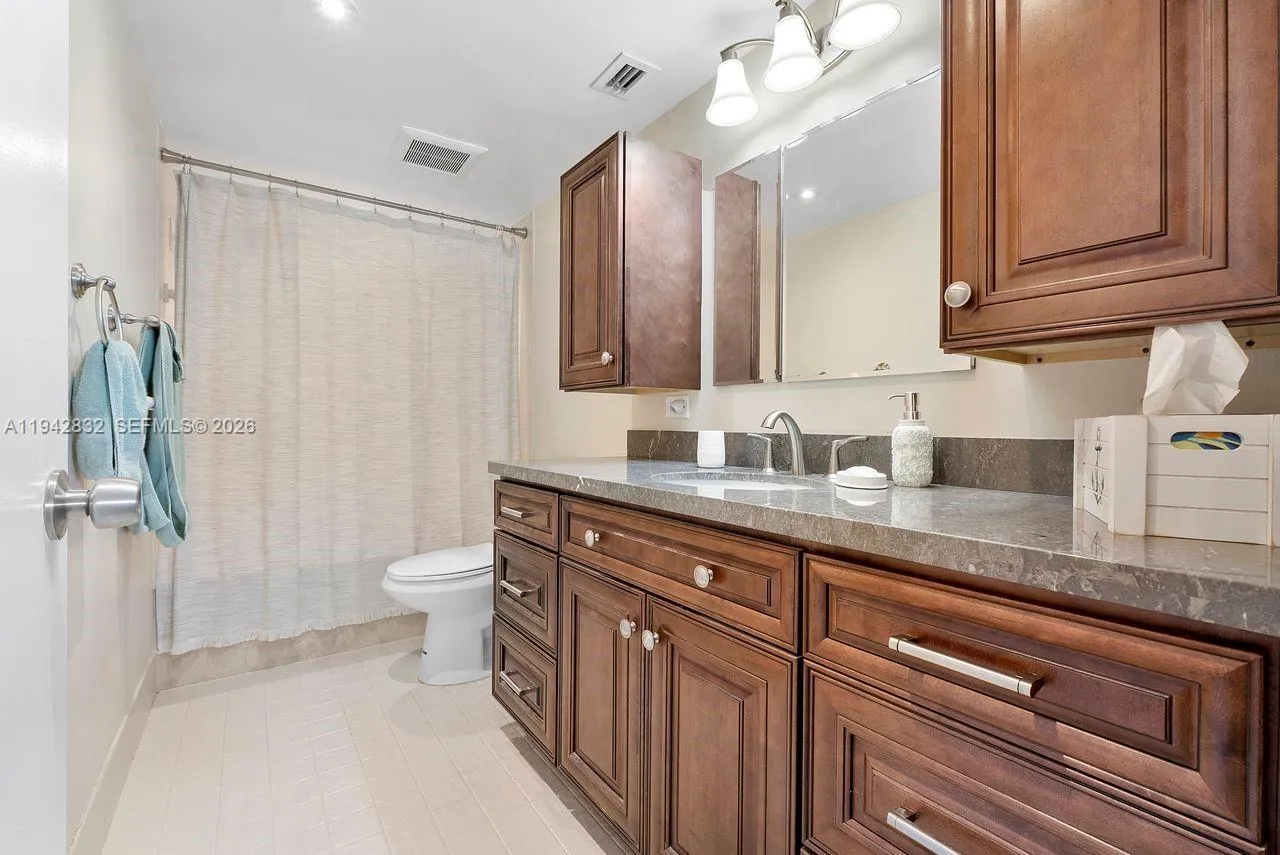 Updated Primary bathroom has a large Roman tub with a combination shower