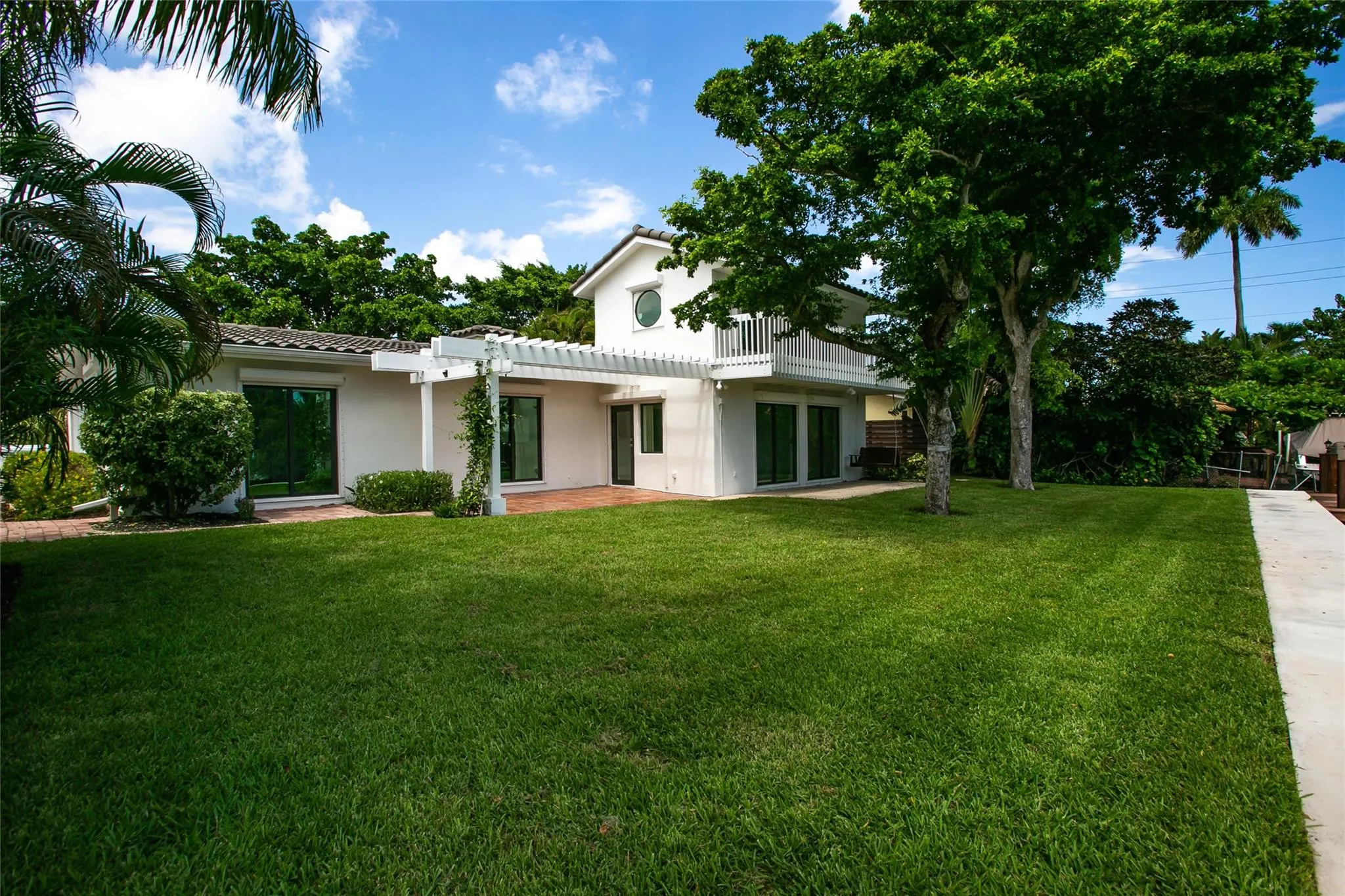 Rear of house with Double patio and expansive lawn