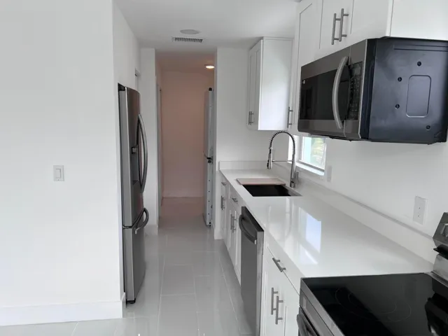 PLENTY OF ROOM FOR DINING BEFORE 12 MONTH OLD REFRIDERATOR AND STORAGE CABINET!