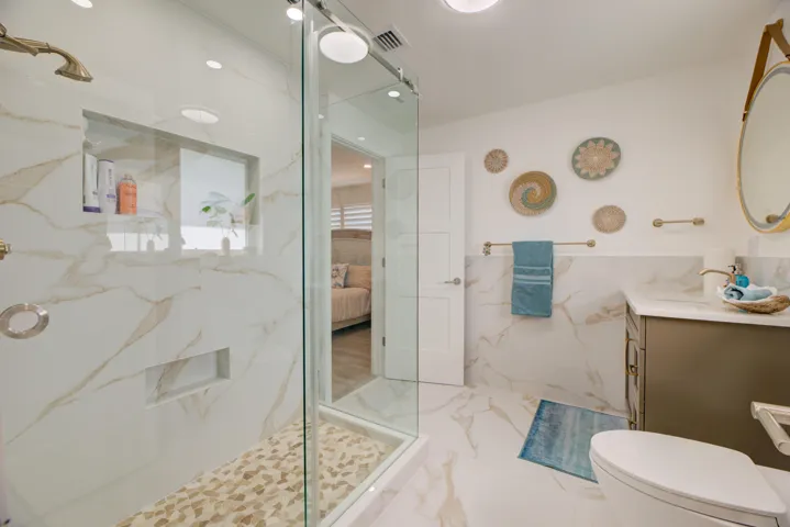 New and beautifully designed full bath. Gorgeous and elegant tiling, lighting and vanity.
