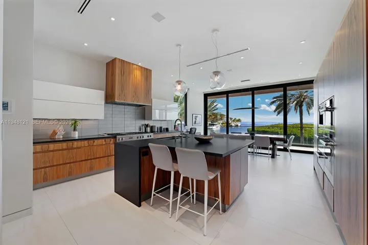 Gourmet Kitchen with high-end appliances, sleek design by Becker, and spectacular views.