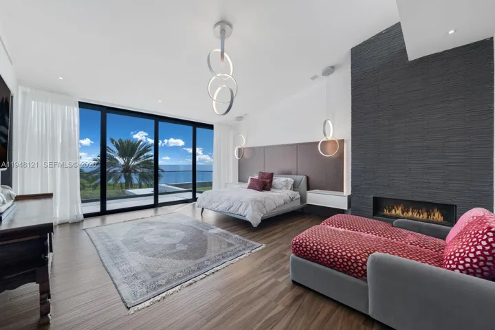 Featured modern textured wall with gas fireplace and views for miles to wake up to in this primary Suite.