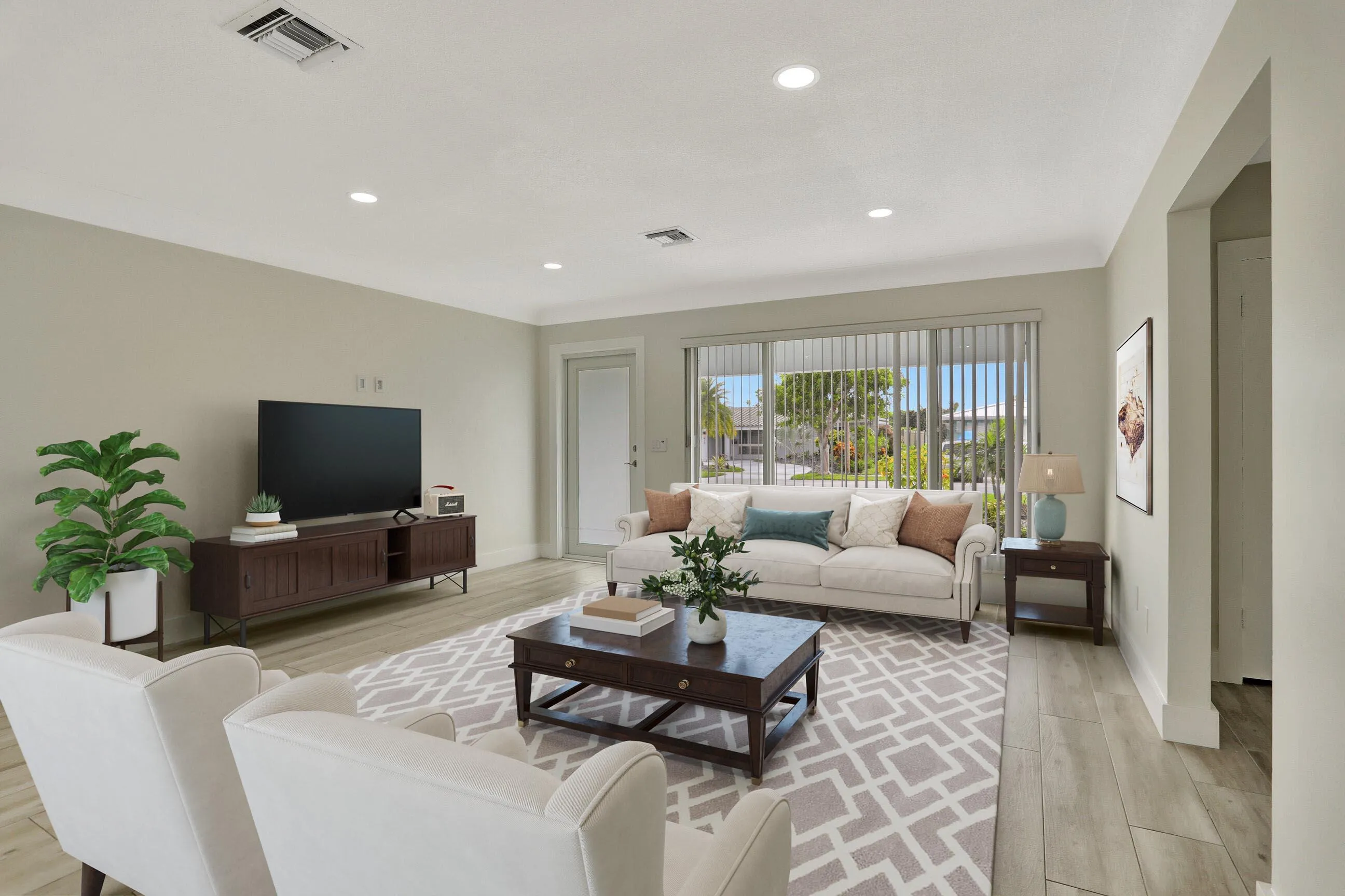 Living room leading to covered patio/pool. This photo is virtually staged.