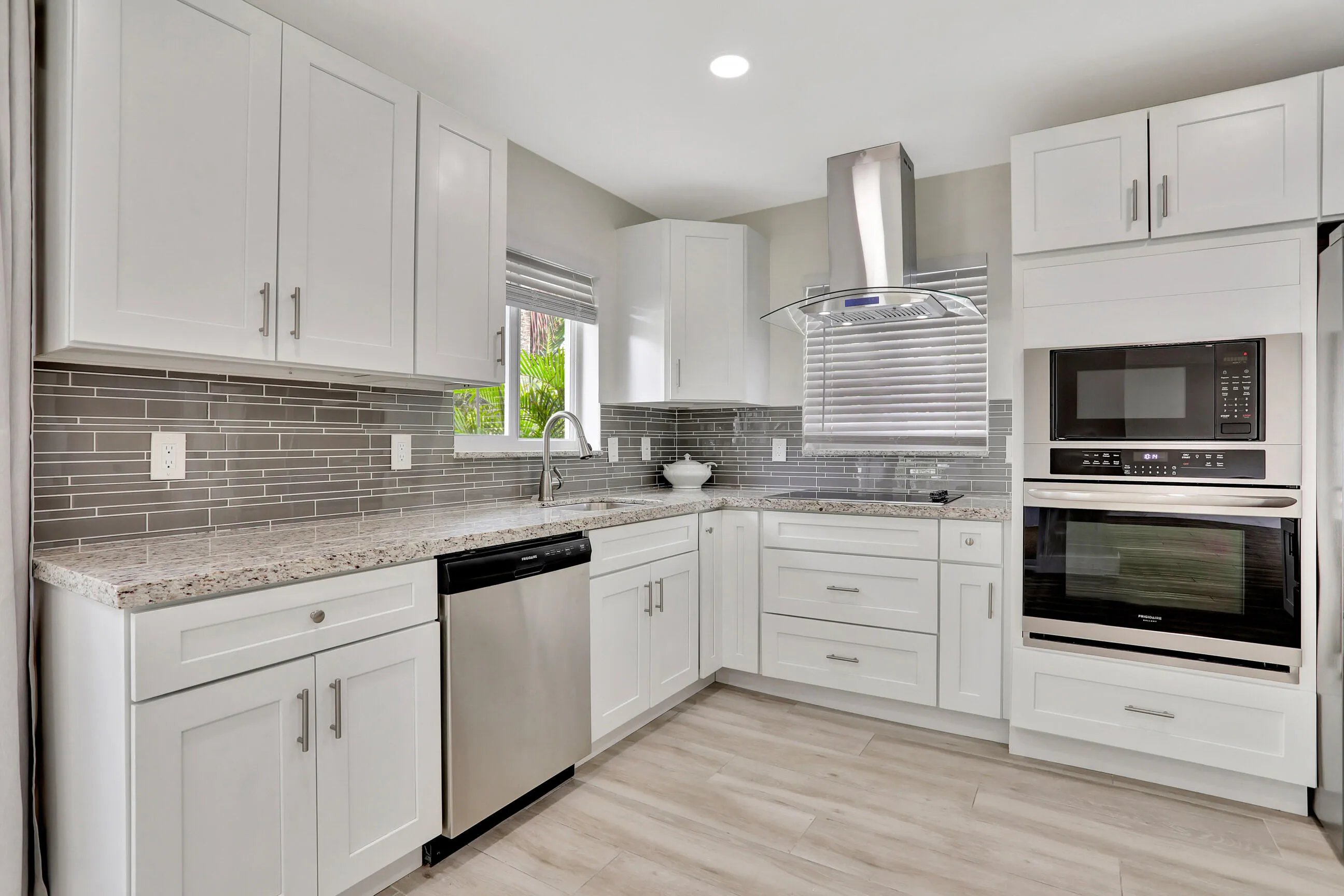 Kitchen with windows showing a serene landscape and water views.