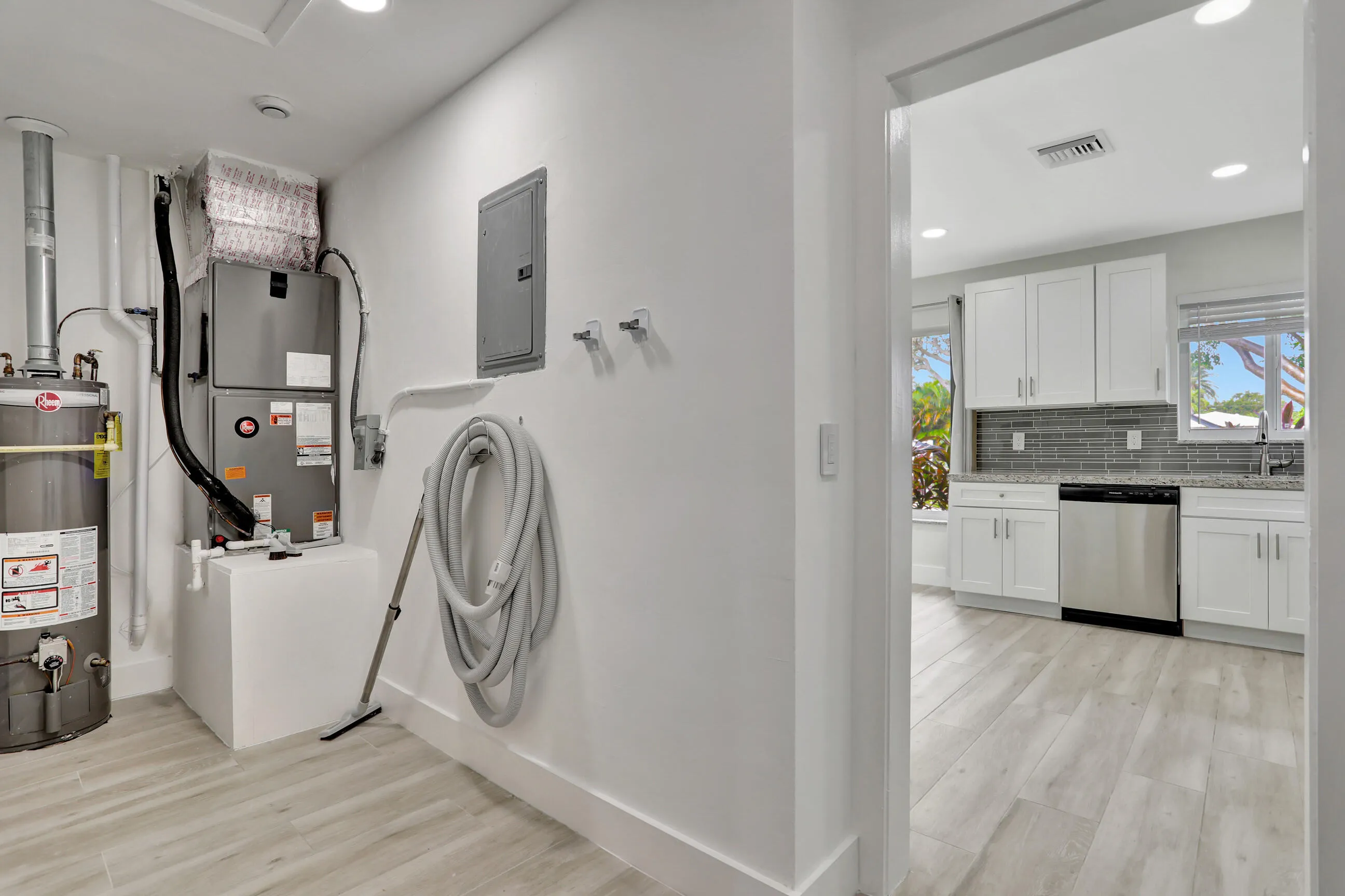 Washer & dryer are on opposite wall in this separate laundry and utility room that can be closed and leads to the garage.