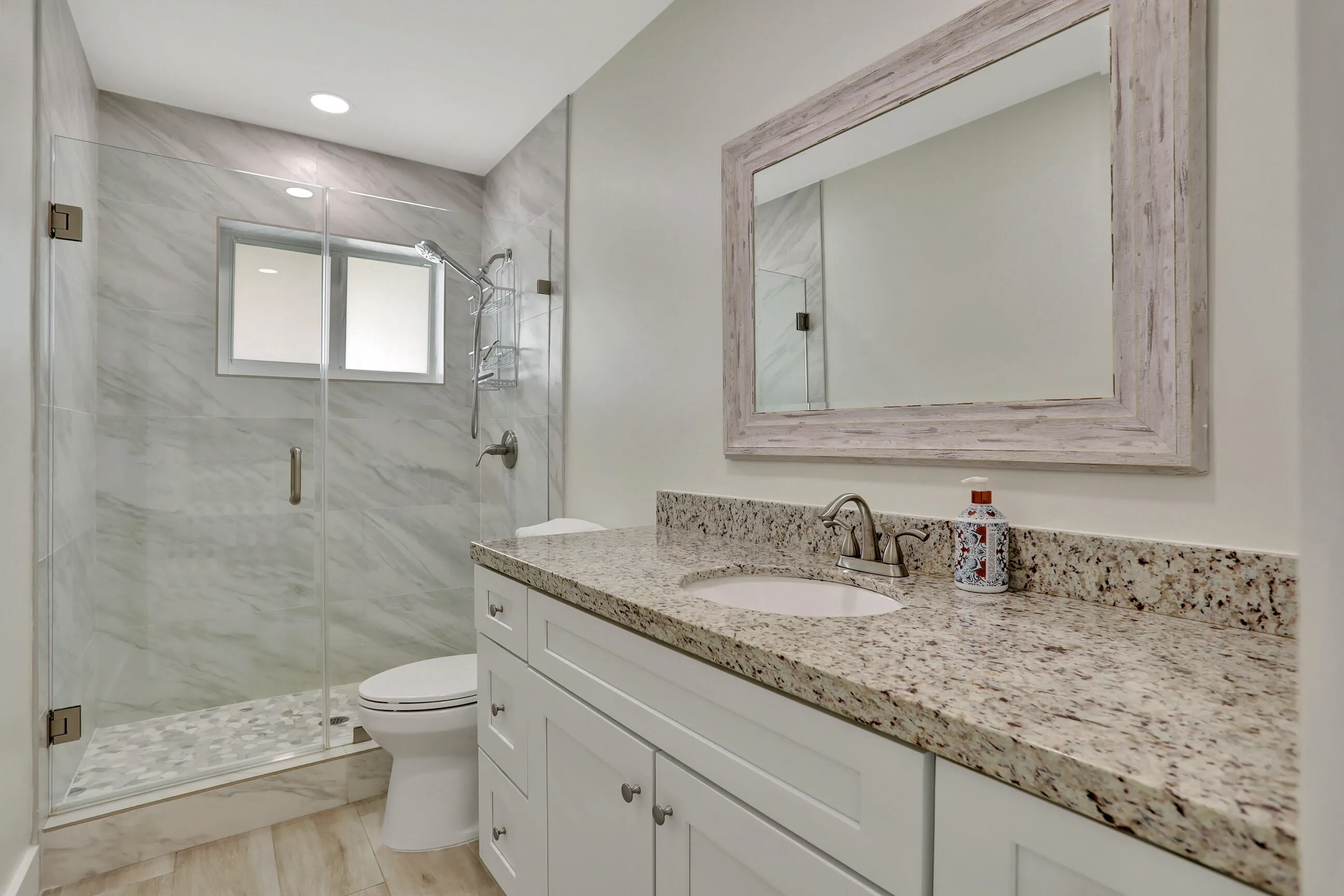 Full size bathroom with bedroom facing the water deck and pool.