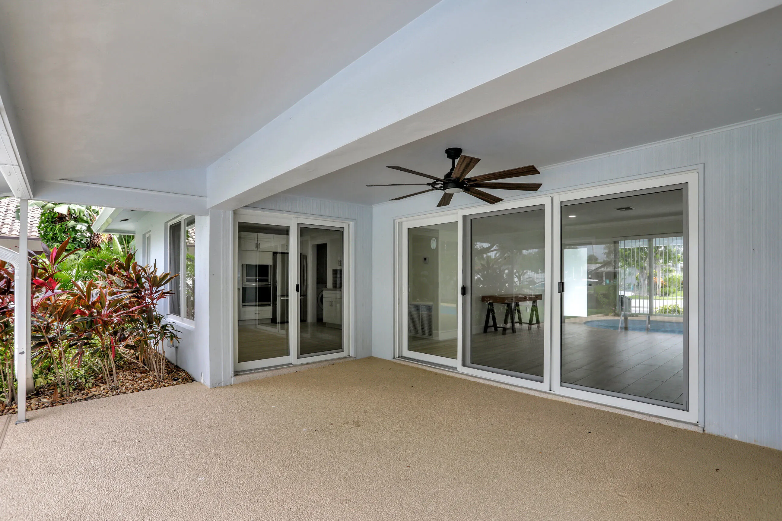 Nice large covered patio with ceiling fan. Updated wall with vertical design.