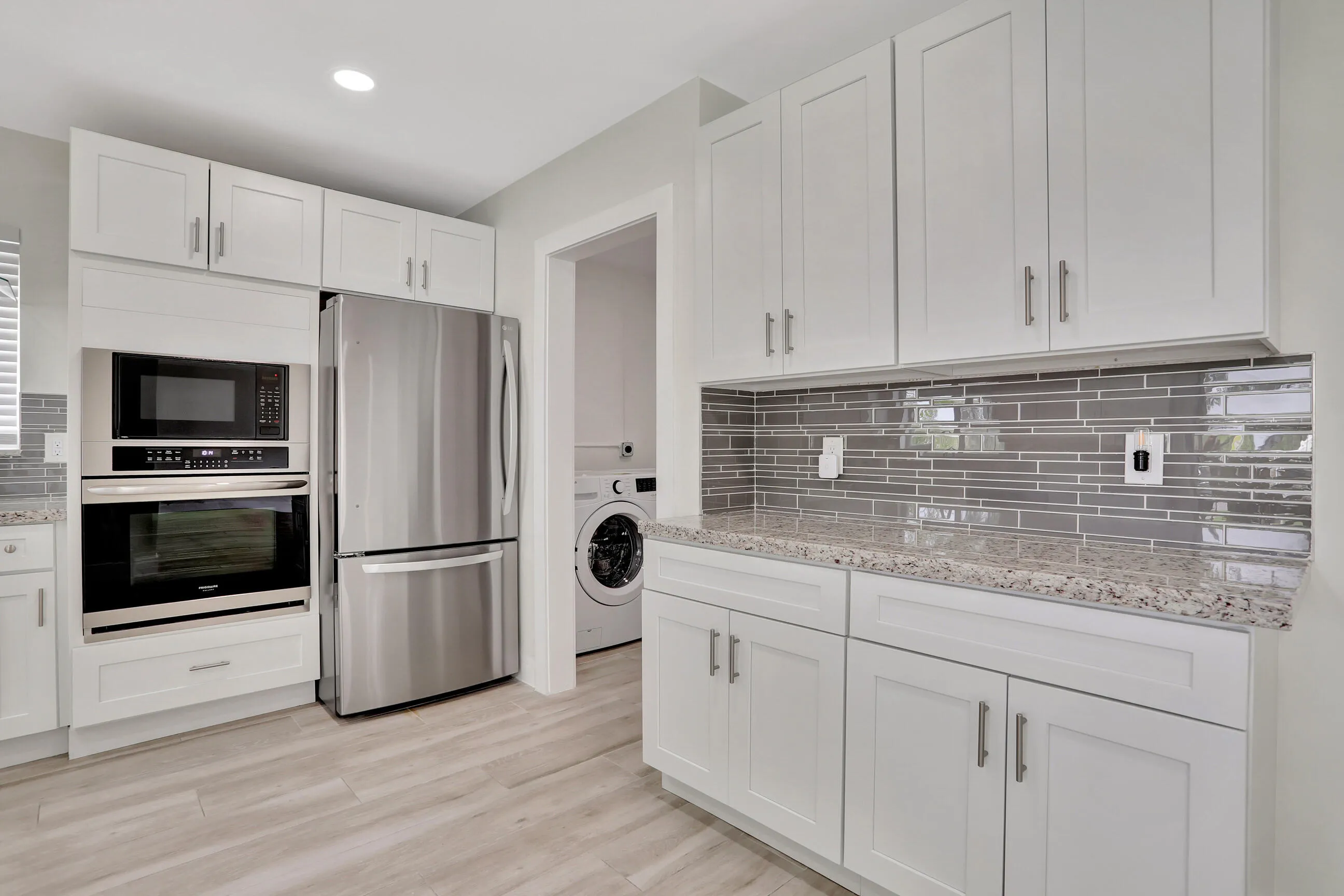Part of kitchen leading to the laundry room and garage.