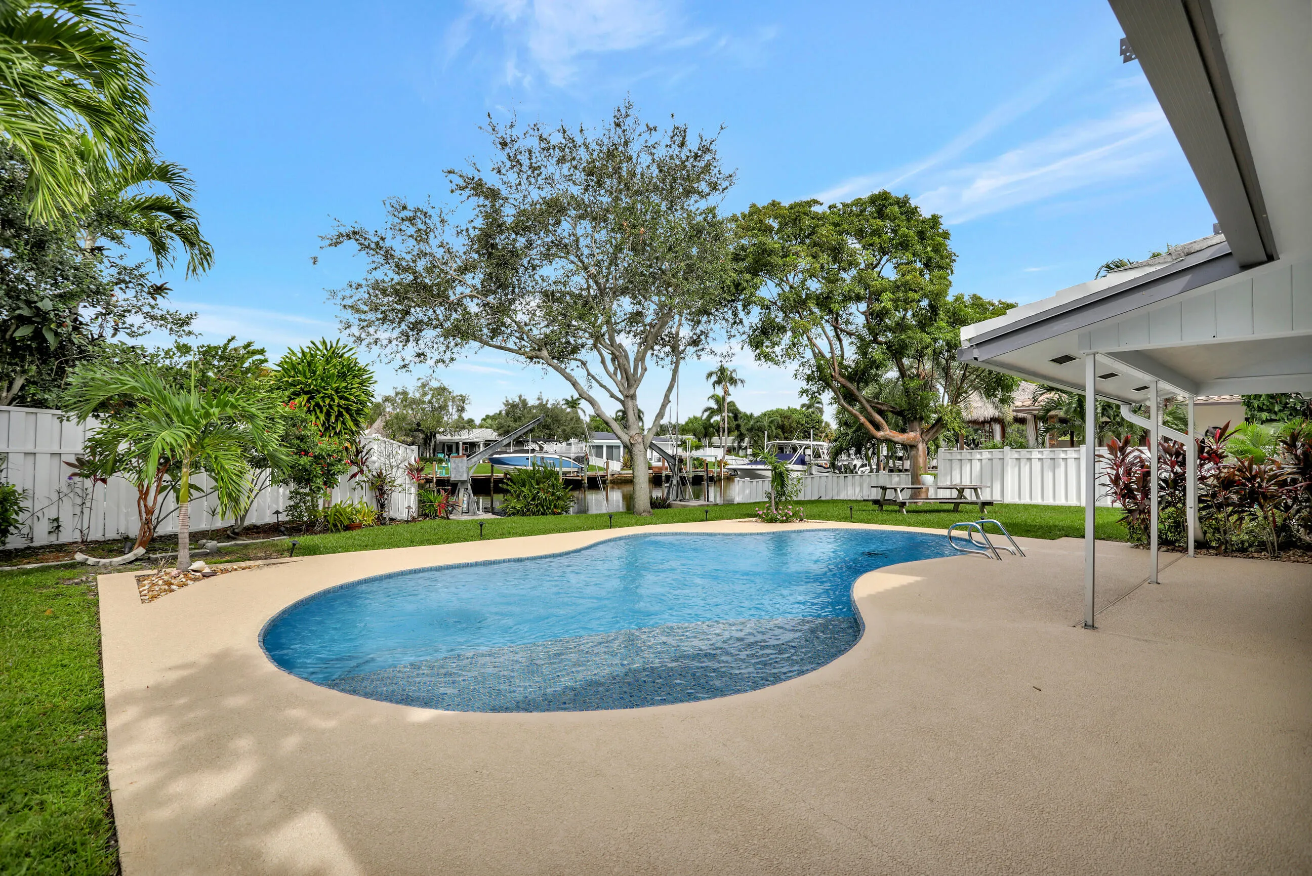 Large pool deck and part of covered patio shown.