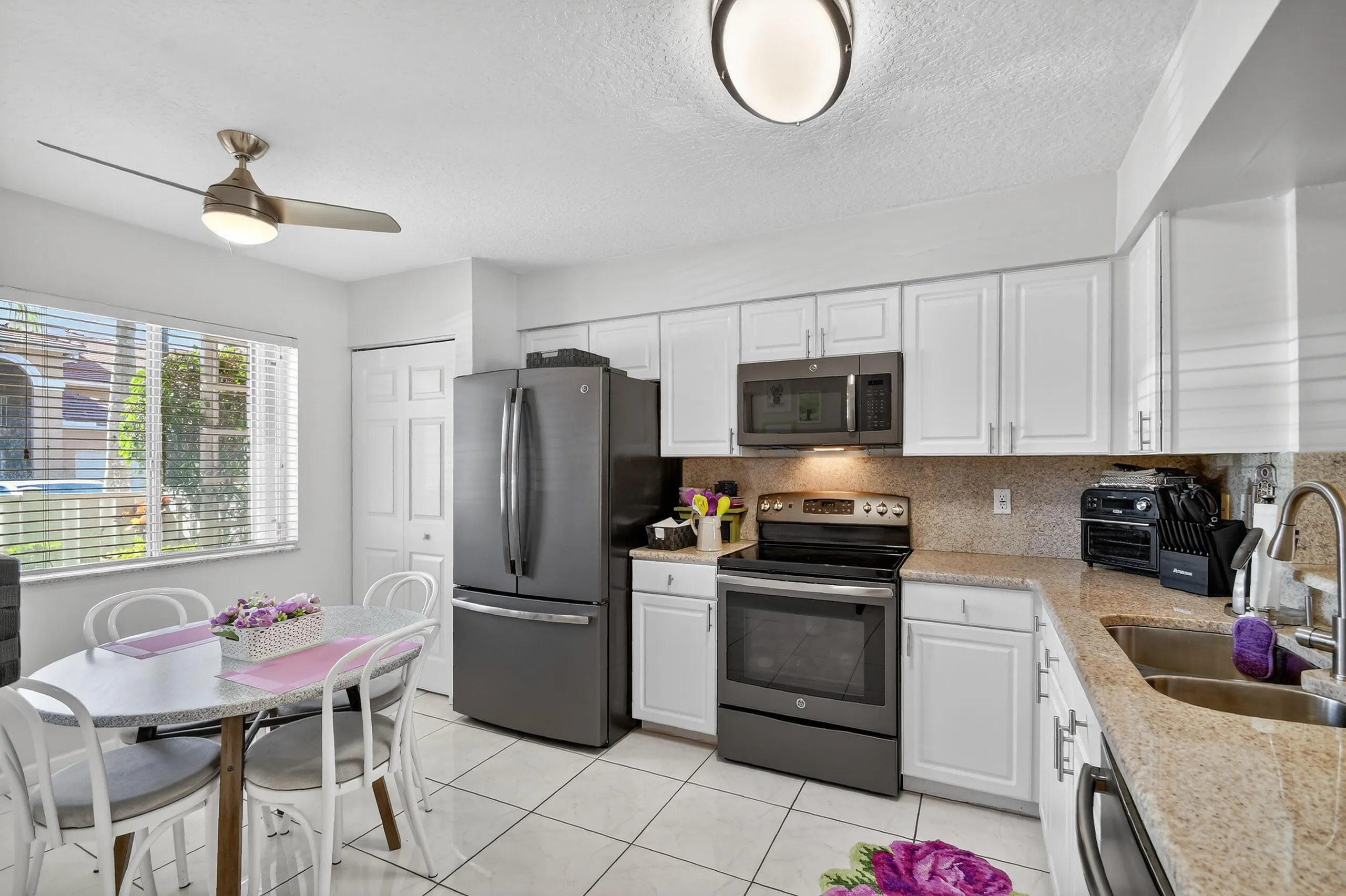 Open, bright, lots of cabinets, GE stainless appliances and a large pantry.