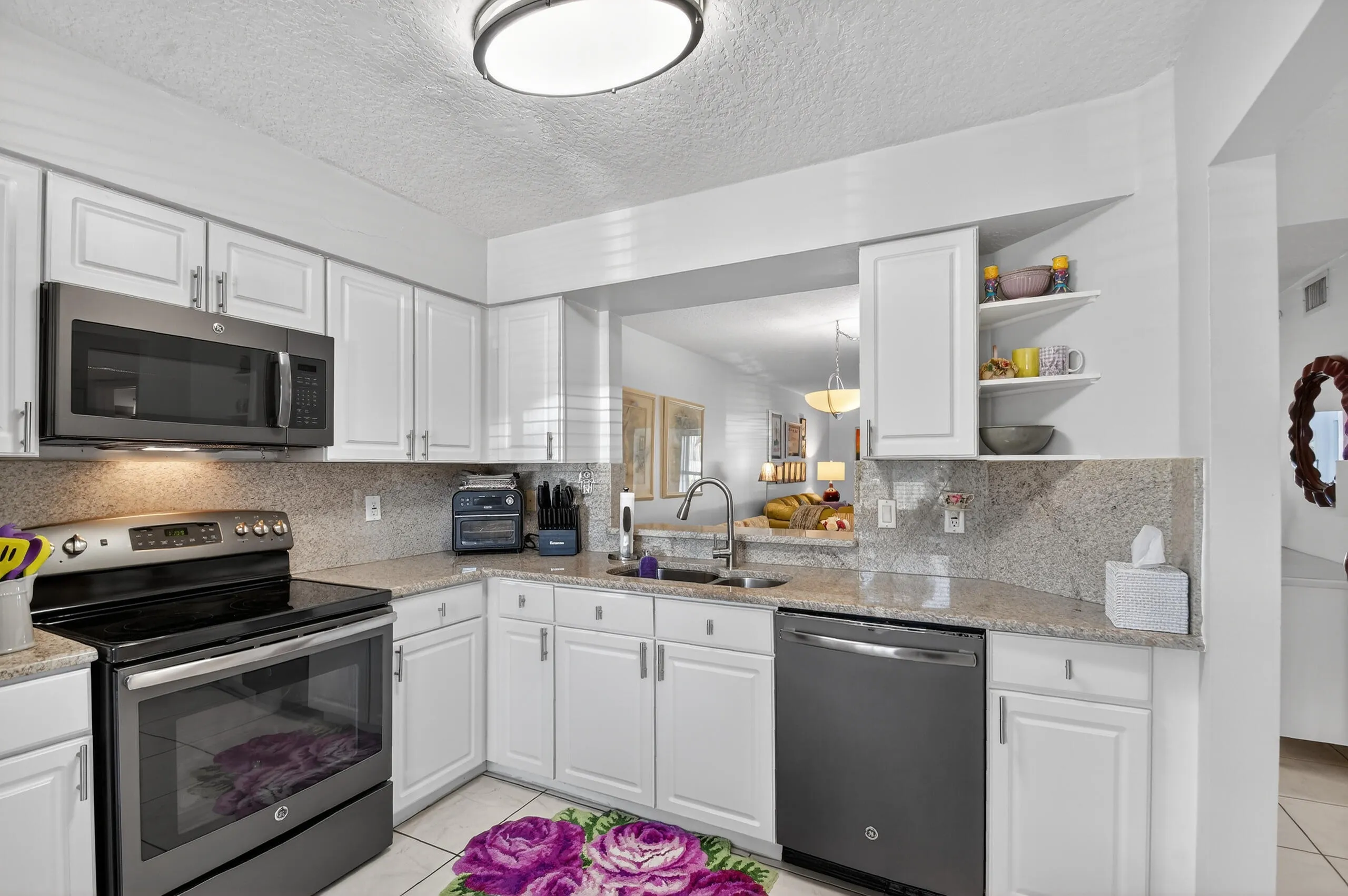 Open, bright, lots of cabinets, GE stainless appliances and a large pantry.