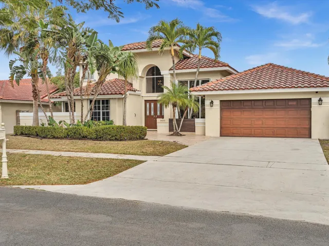 Front exterior view showcasing the home’s façade, driveway, and two-car garage.