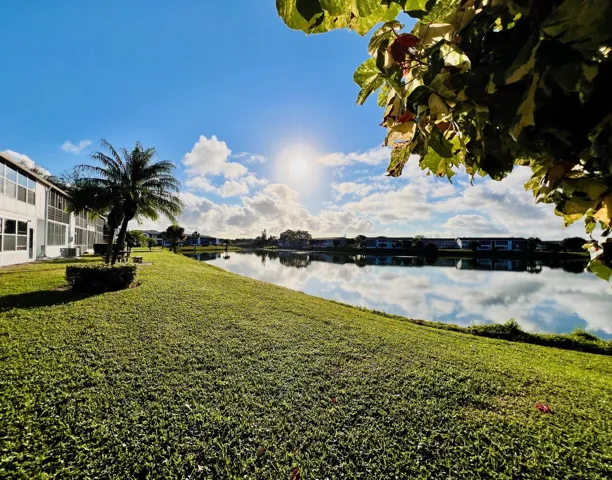 Gorgeous WATER VIEWS! Lovely FIRST FLOOR 2/1.5 Century Village Condo.