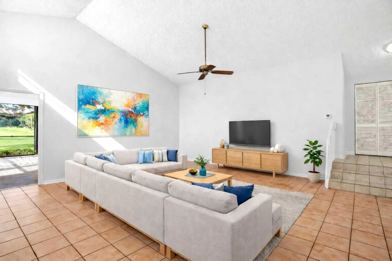 Spacious living room with 14' soaring ceiling is ready for movie night.