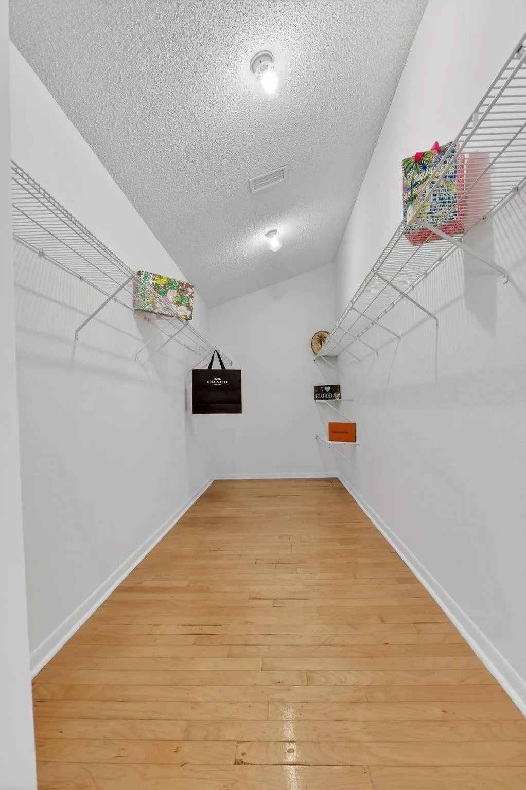 17 foot long walk in closet with hardwood floors is perfect for fashion fans.
