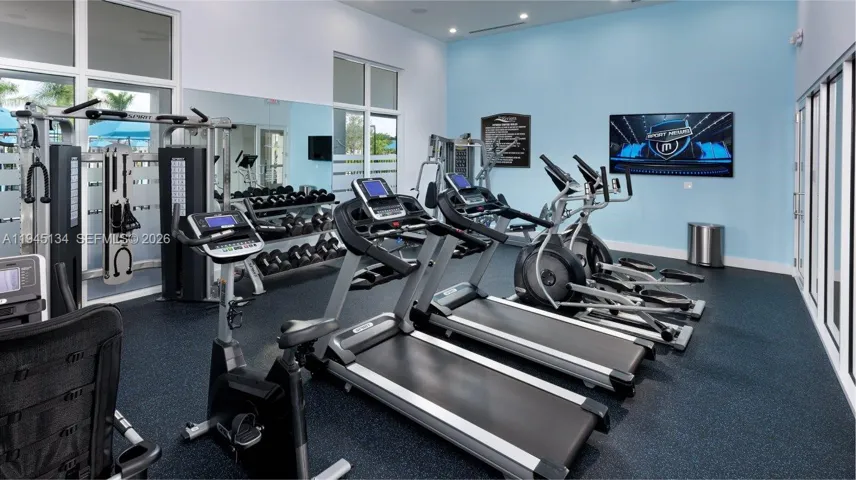 Fully equipped fitness center featuring modern exercise equipment, providing convenience and flexibility just steps from home.