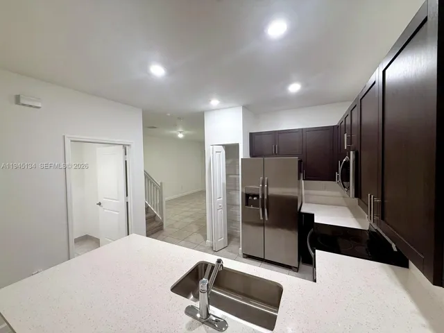 Open-concept kitchen featuring a large island, ample counter space, and modern finishes that flow seamlessly into the living area.