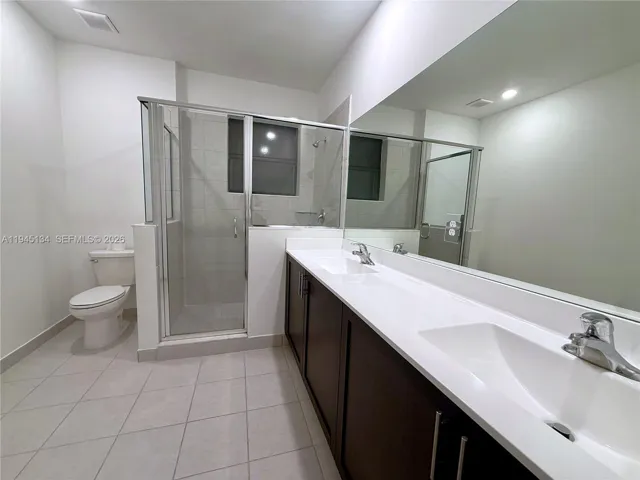 Primary bathroom featuring dual sinks, modern cabinetry, and a spacious vanity designed for comfort and functionality.