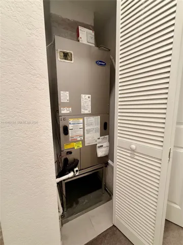 Hallway storage area with utility access, providing practical space for organization and household essentials.