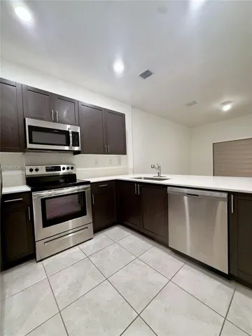 Another view of the kitchen highlighting its clean lines, updated appliances, and efficient layout ideal for cooking and entertaining.