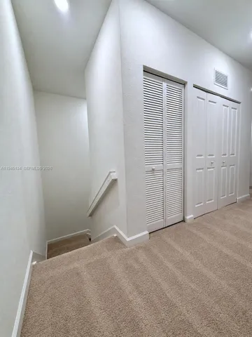 Upstairs hallway connecting bedrooms and living areas, offering a clean and cohesive flow throughout the second level.