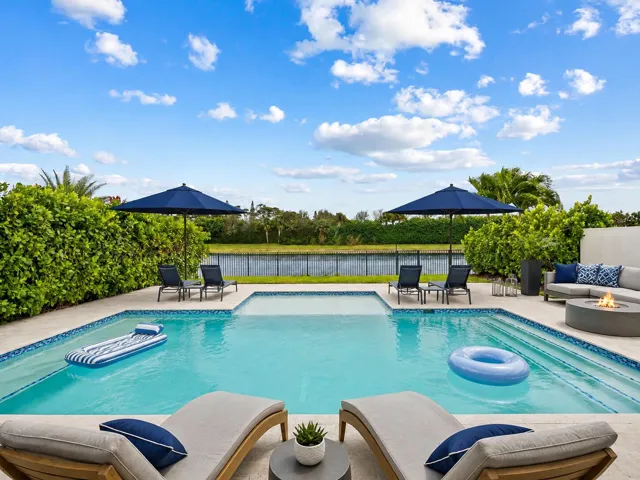 The newly installed pool, extended patio and lake view and lounge chairs are an actual photo. Other furniture and floats are virtually added.