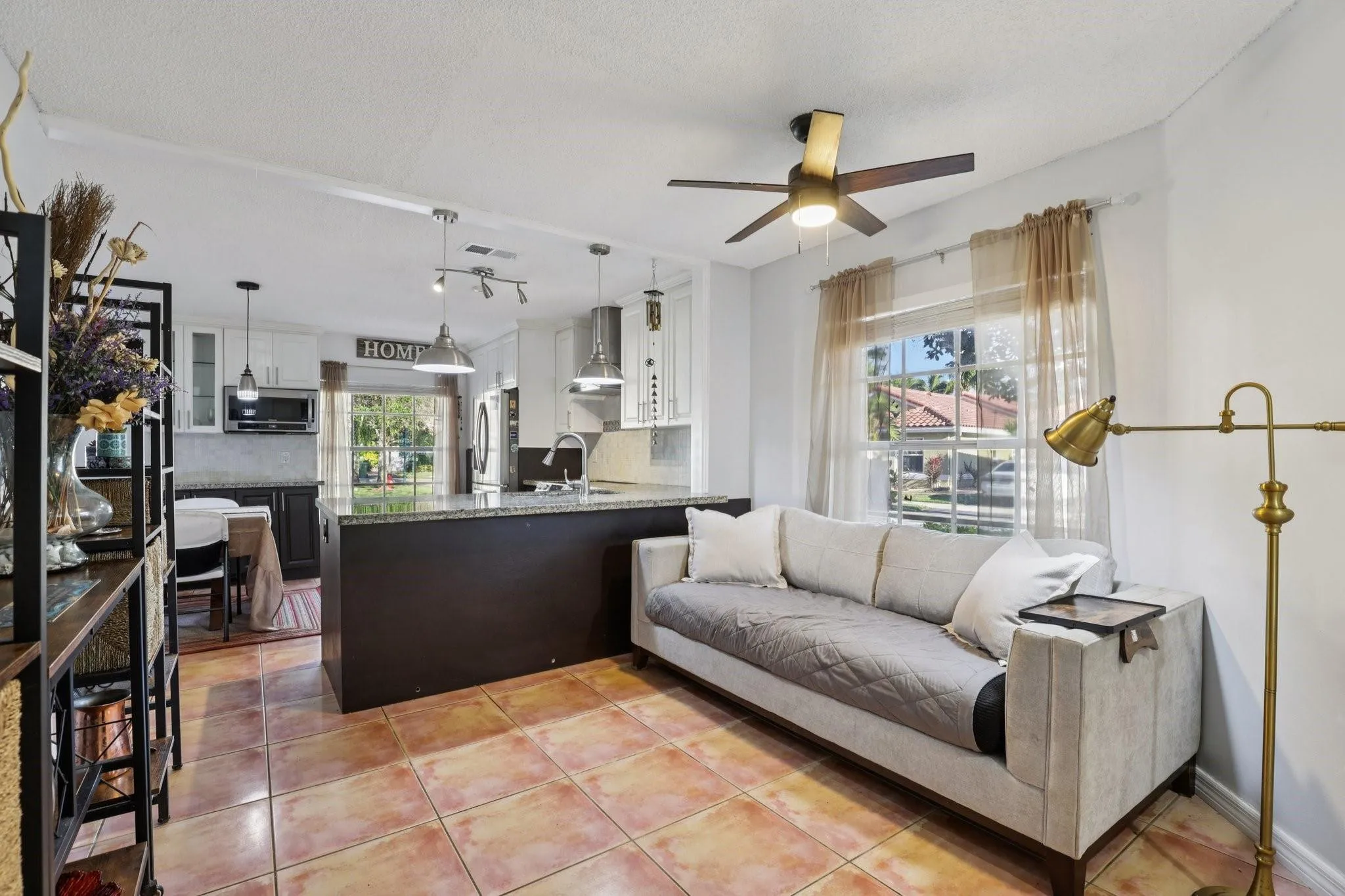 Its open layout encourages interaction with the kitchen and dining areas, making it ideal for entertaining or spending quality time with family.