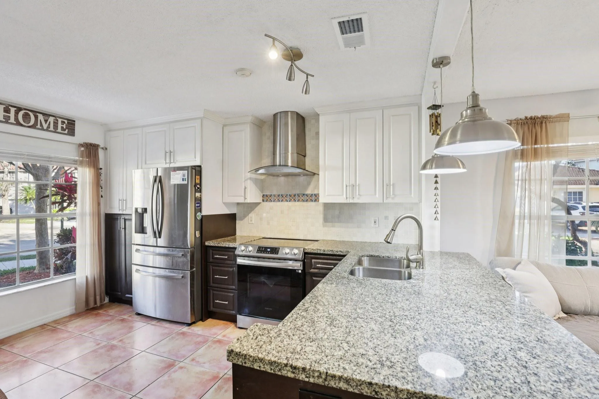 The open connection to the dining and family room enhances the sense of openness and allows for seamless interaction while cooking