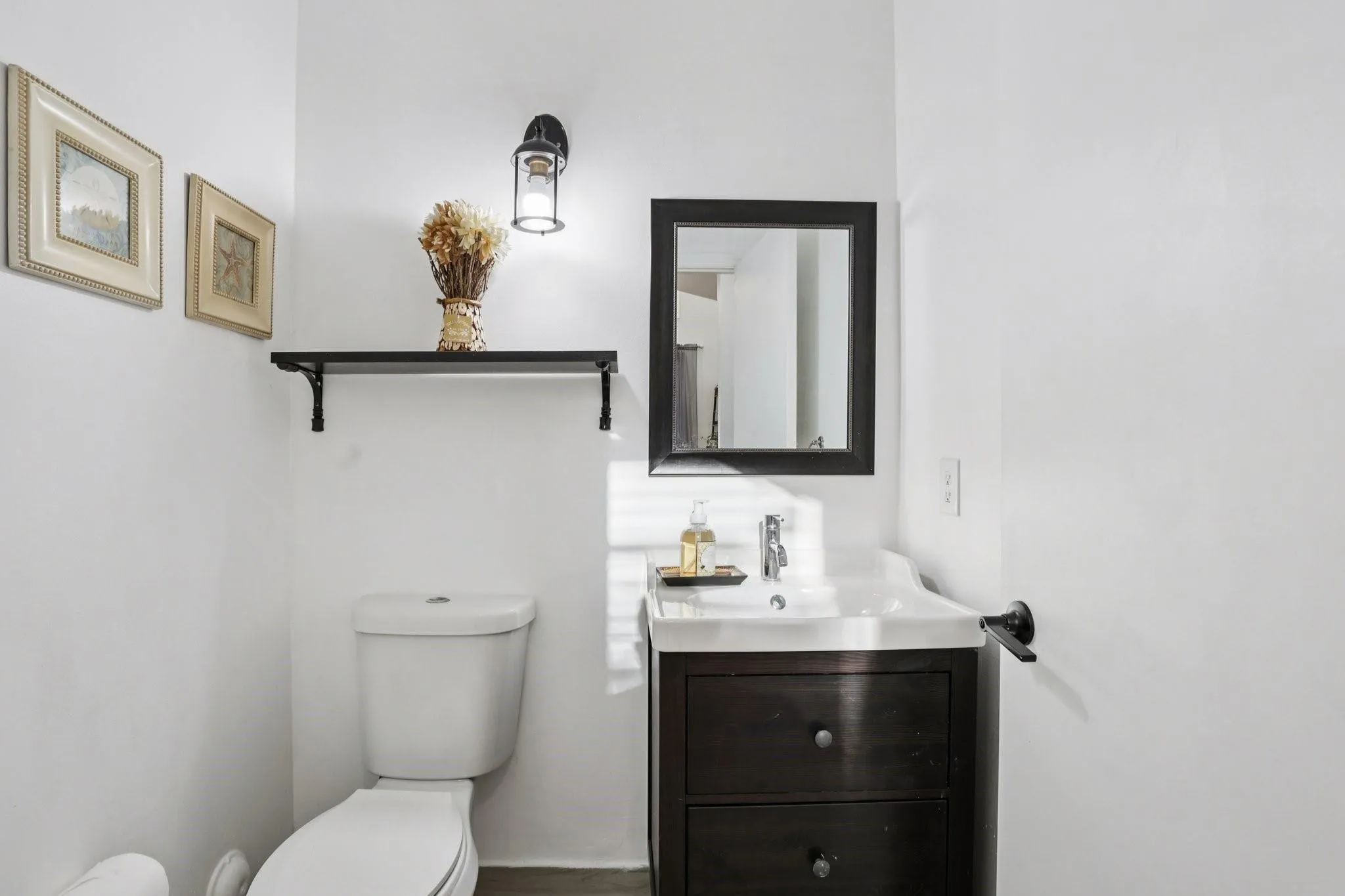 The first-floor half bathroom is strategically placed for guest convenience. Designed with functionality in mind, it offers easy access from the main living areas while maintaining privacy.