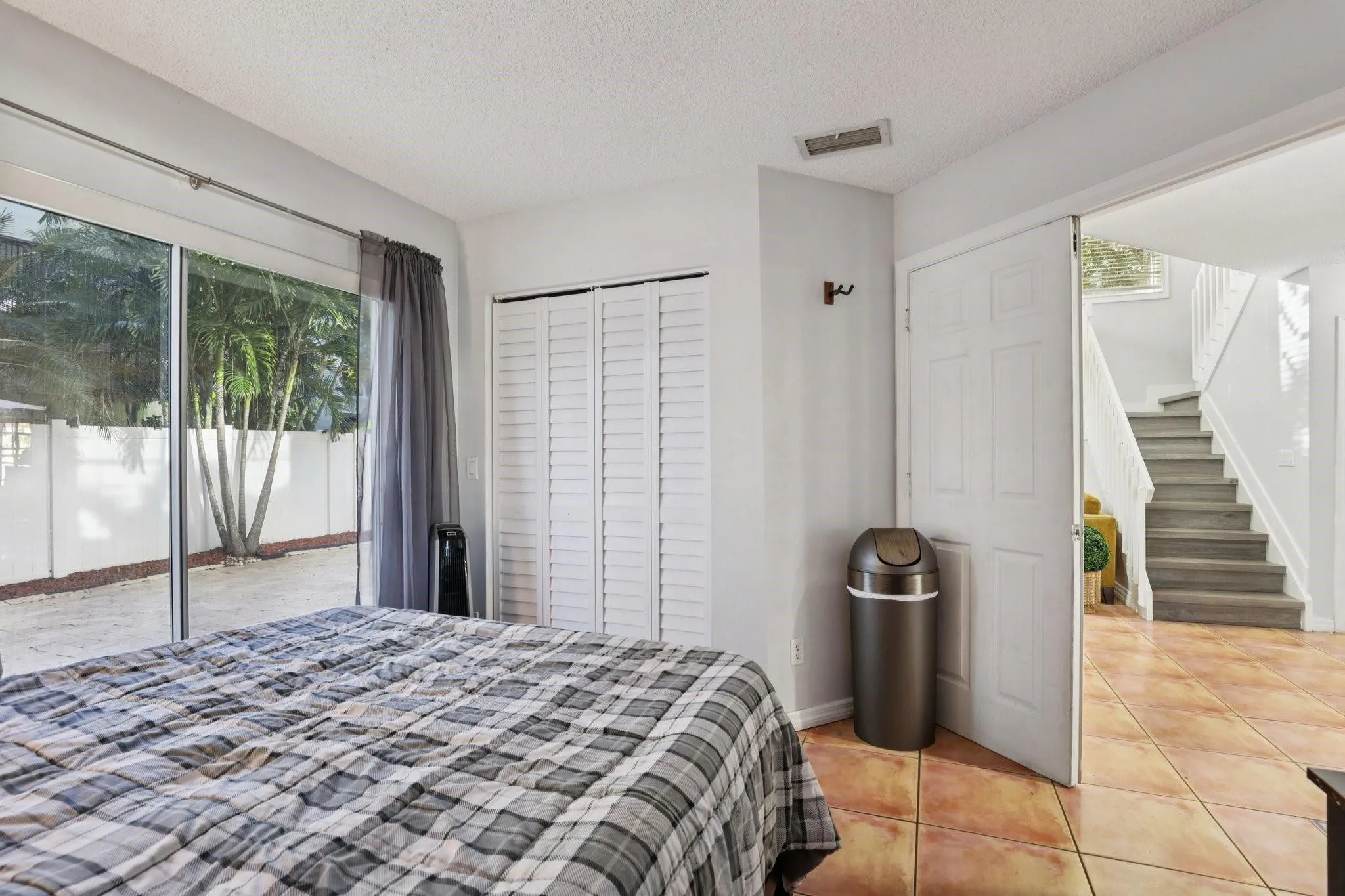 The first-floor bedroom provides a versatile space suitable for guests, a home office, or private use.