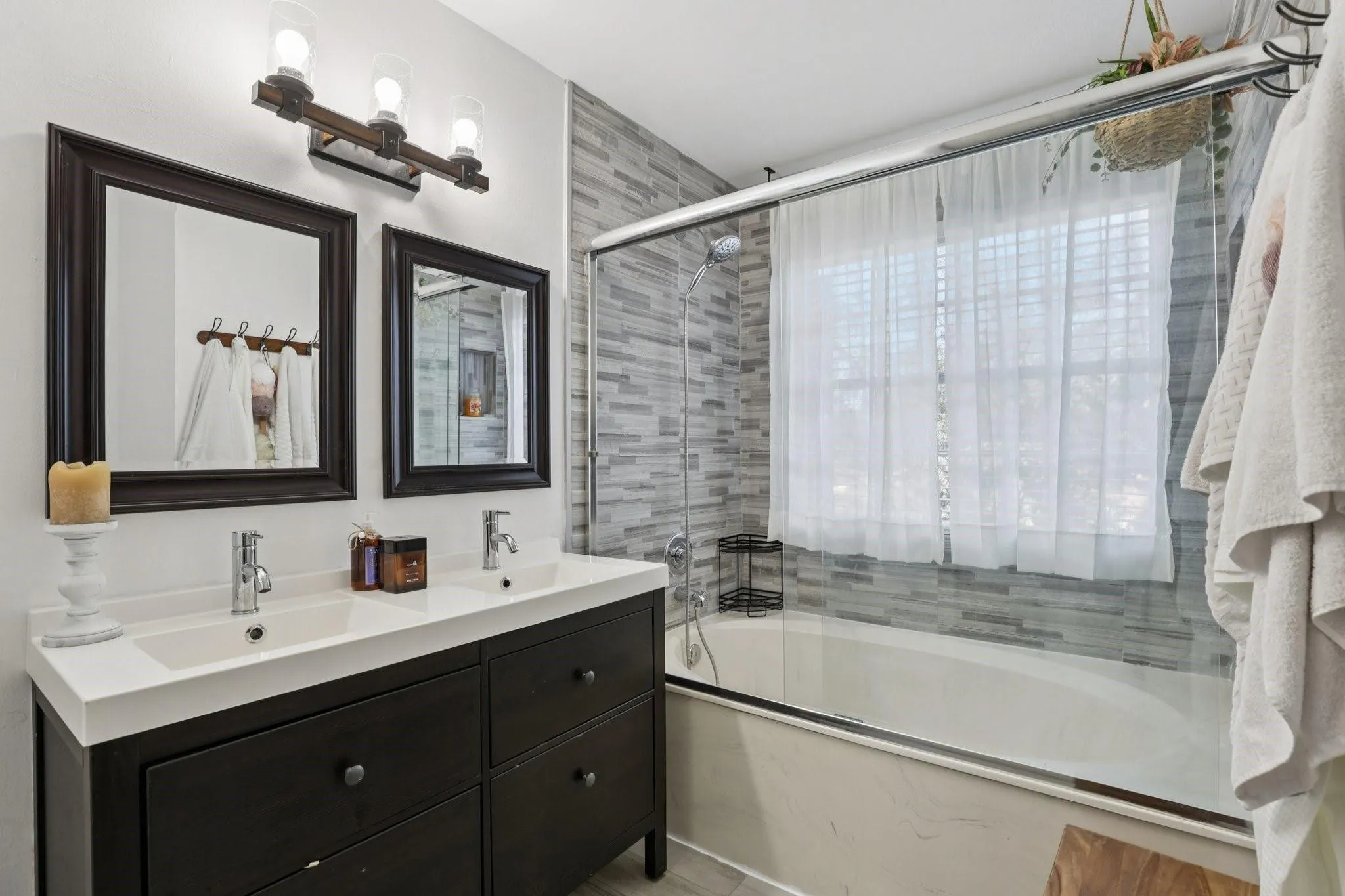 The space offers comfortable proportions and thoughtful placement of fixtures to accommodate multiple users. Its neutral design allows for easy personalization while maintaining a clean, well-organized feel.