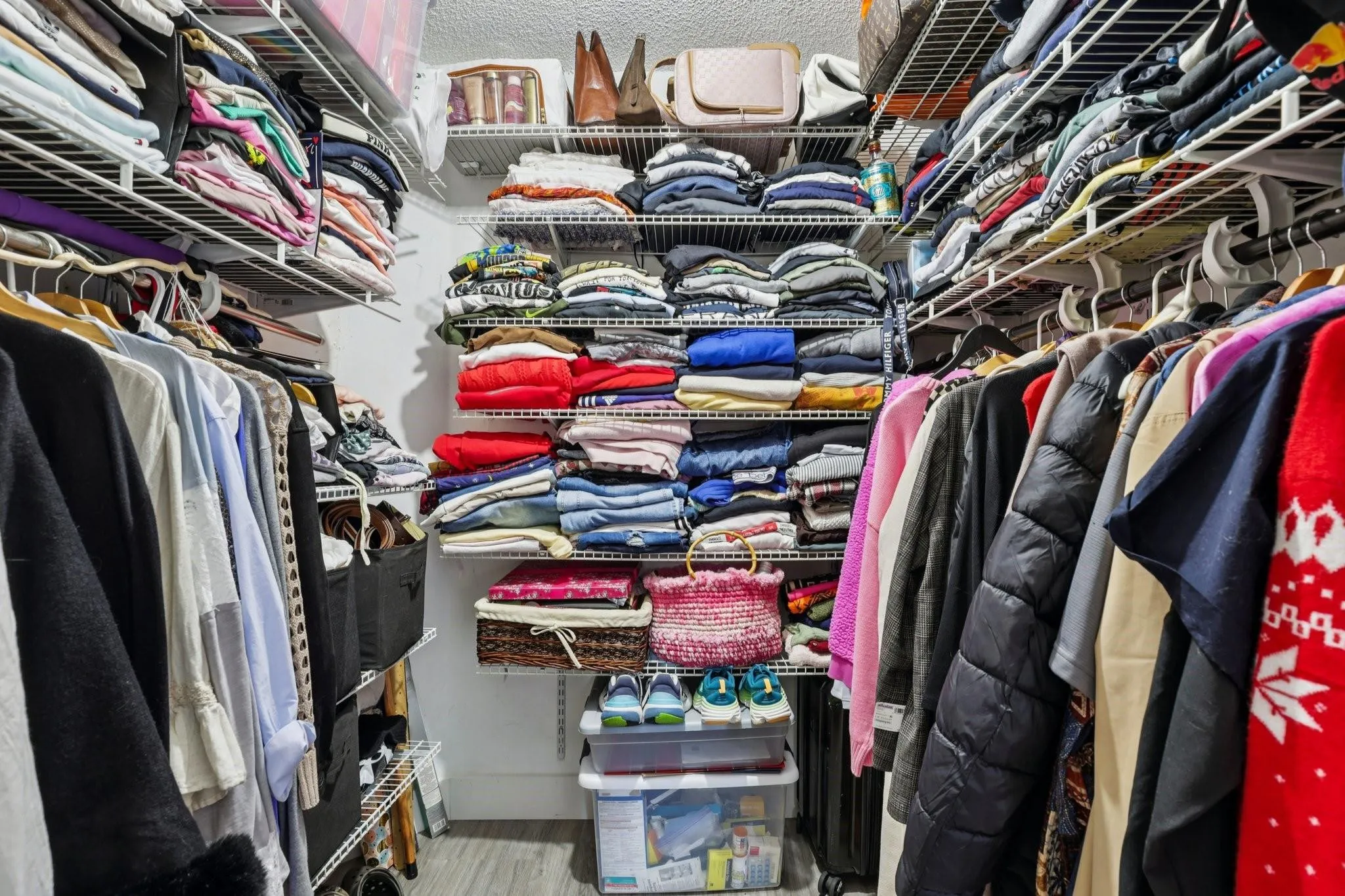 The primary closet offers dedicated storage with convenient access from both the bedroom and bathroom. Its layout supports organization and functionality, providing ample space for wardrobe and accessories.