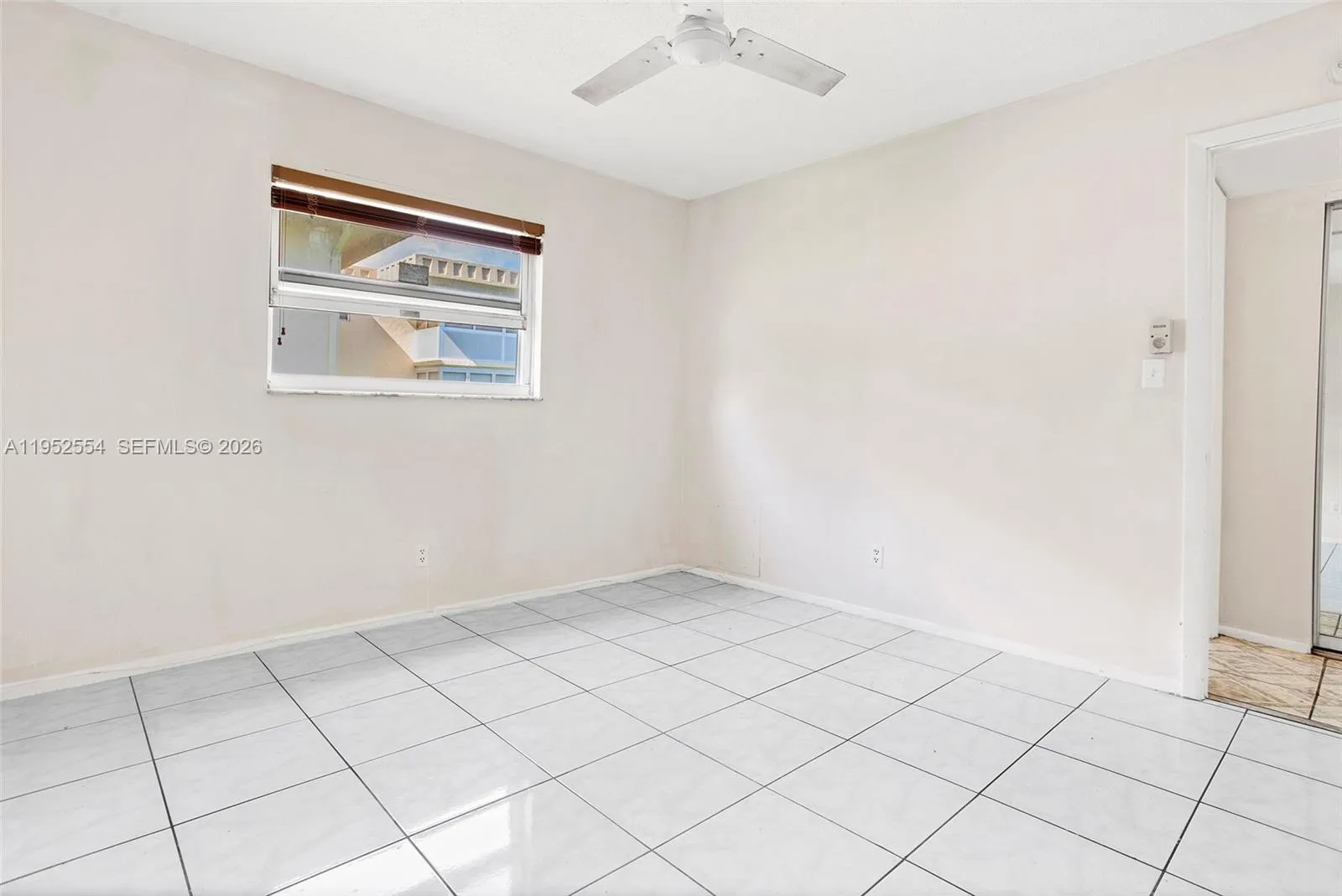 GUEST BEDROOM WITH CLEAN TILE FLOORING