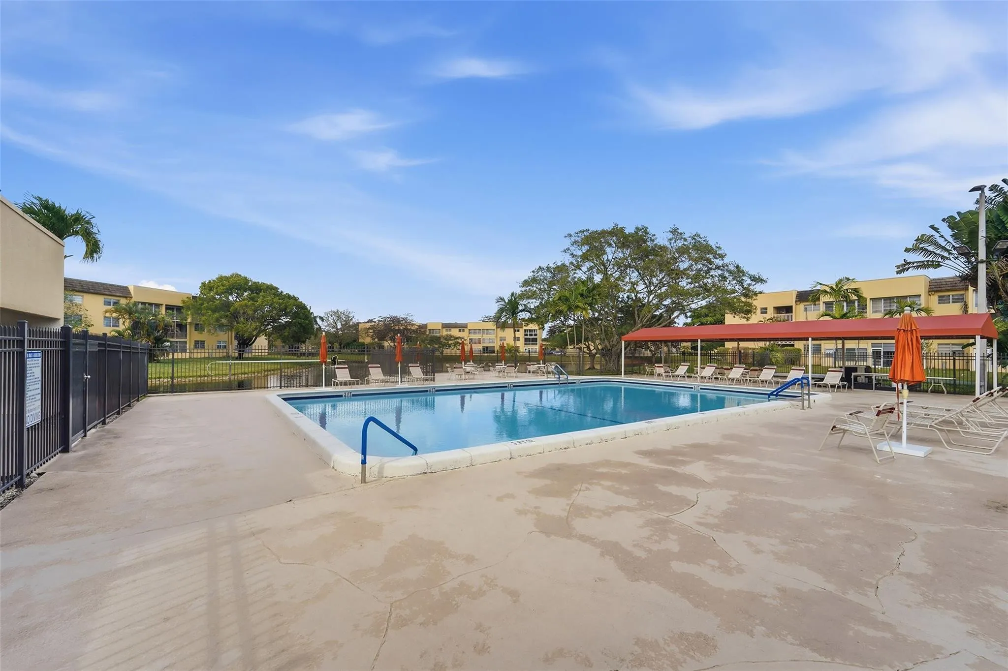 Pool has sun shade seating area
