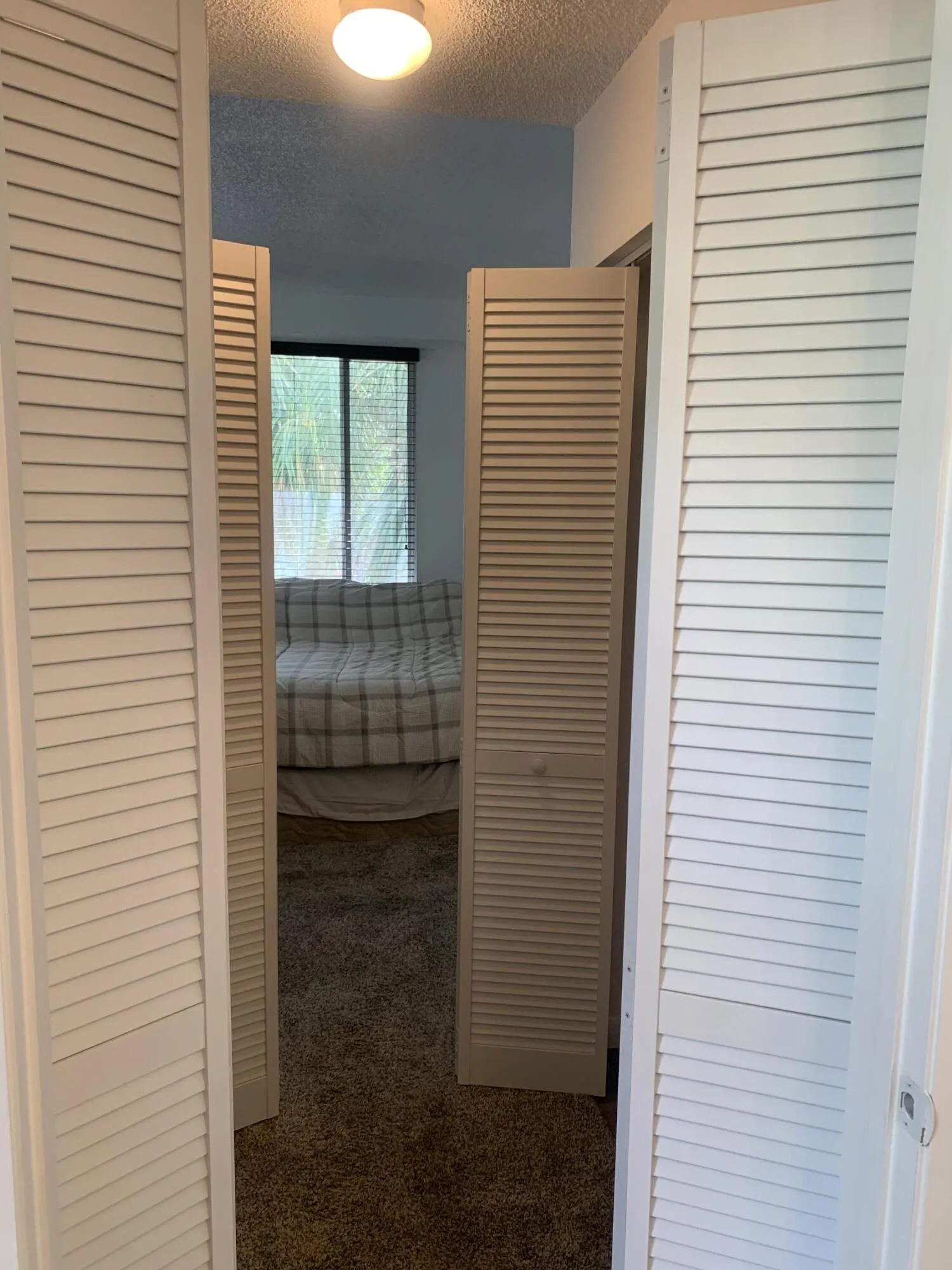 Hallway from the bathroom facing the bed