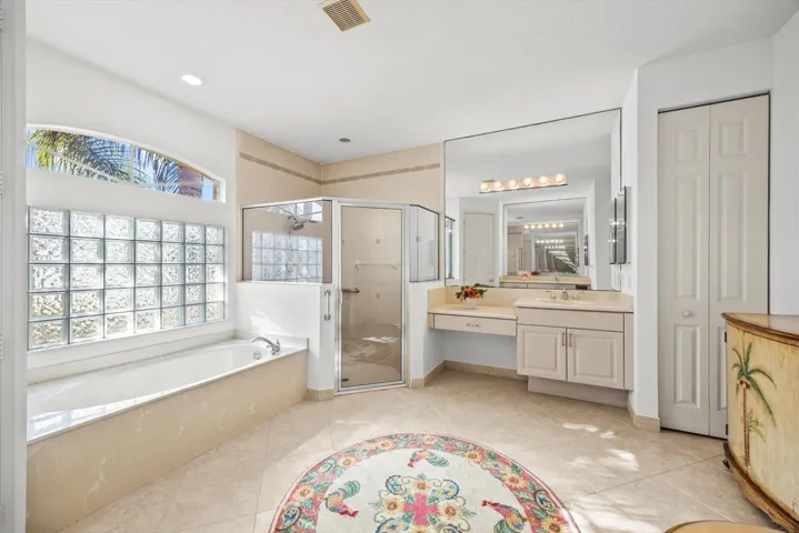 Spacious primary bathroom with dual vanities and separate roman tub/shower....