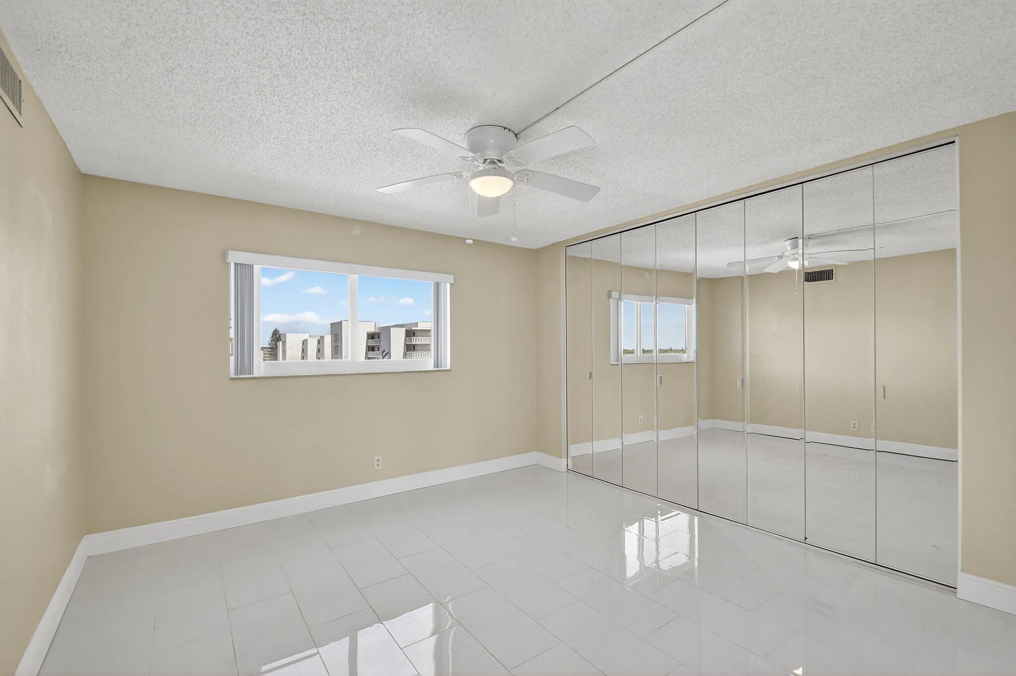 Custom Mirrored Panels with a wall of storage
