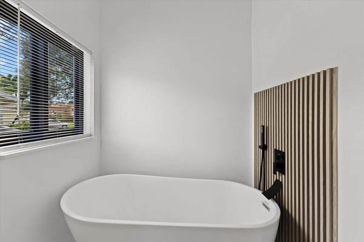 Freestanding soaking tub in Master bathroom.