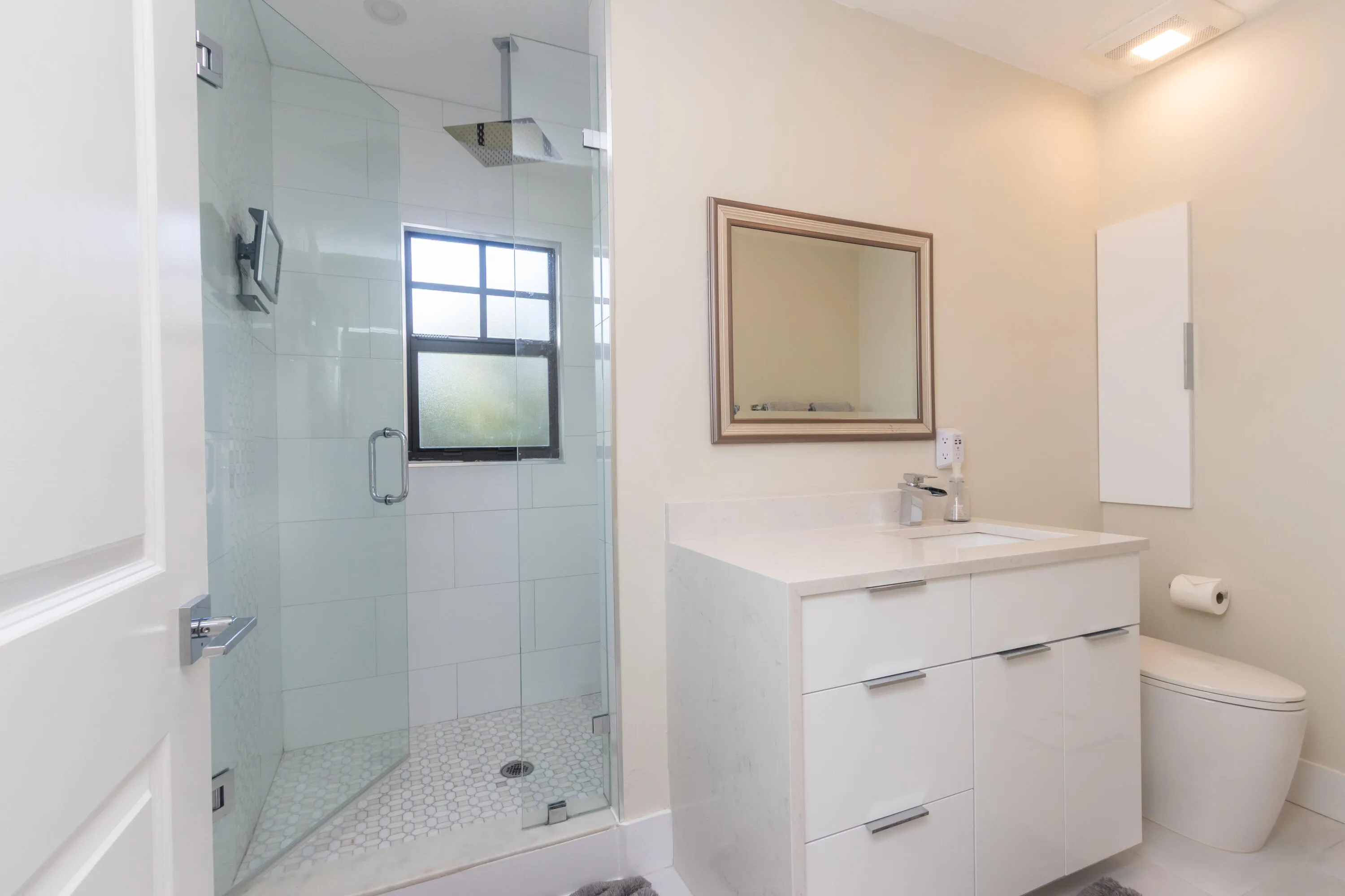 Luxurious master bath with porcelain tile, rainfall shower head, & apron toilet
