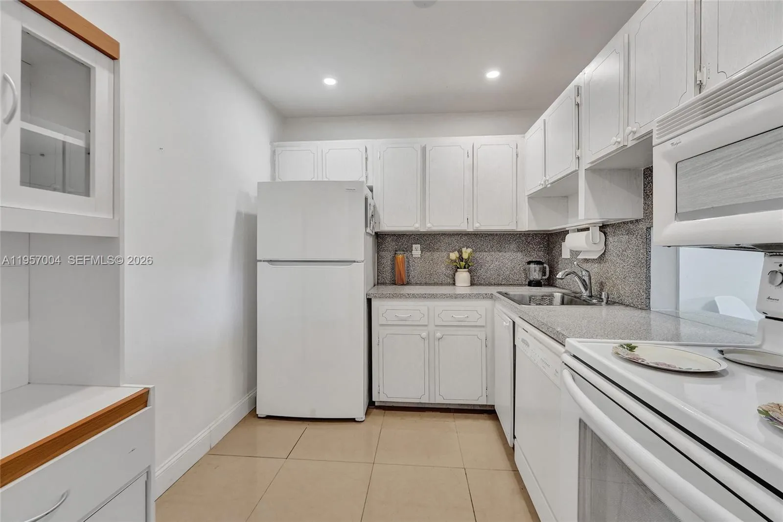 Spacious kitchen with sleek tile floors, offering a clean and modern aesthetic