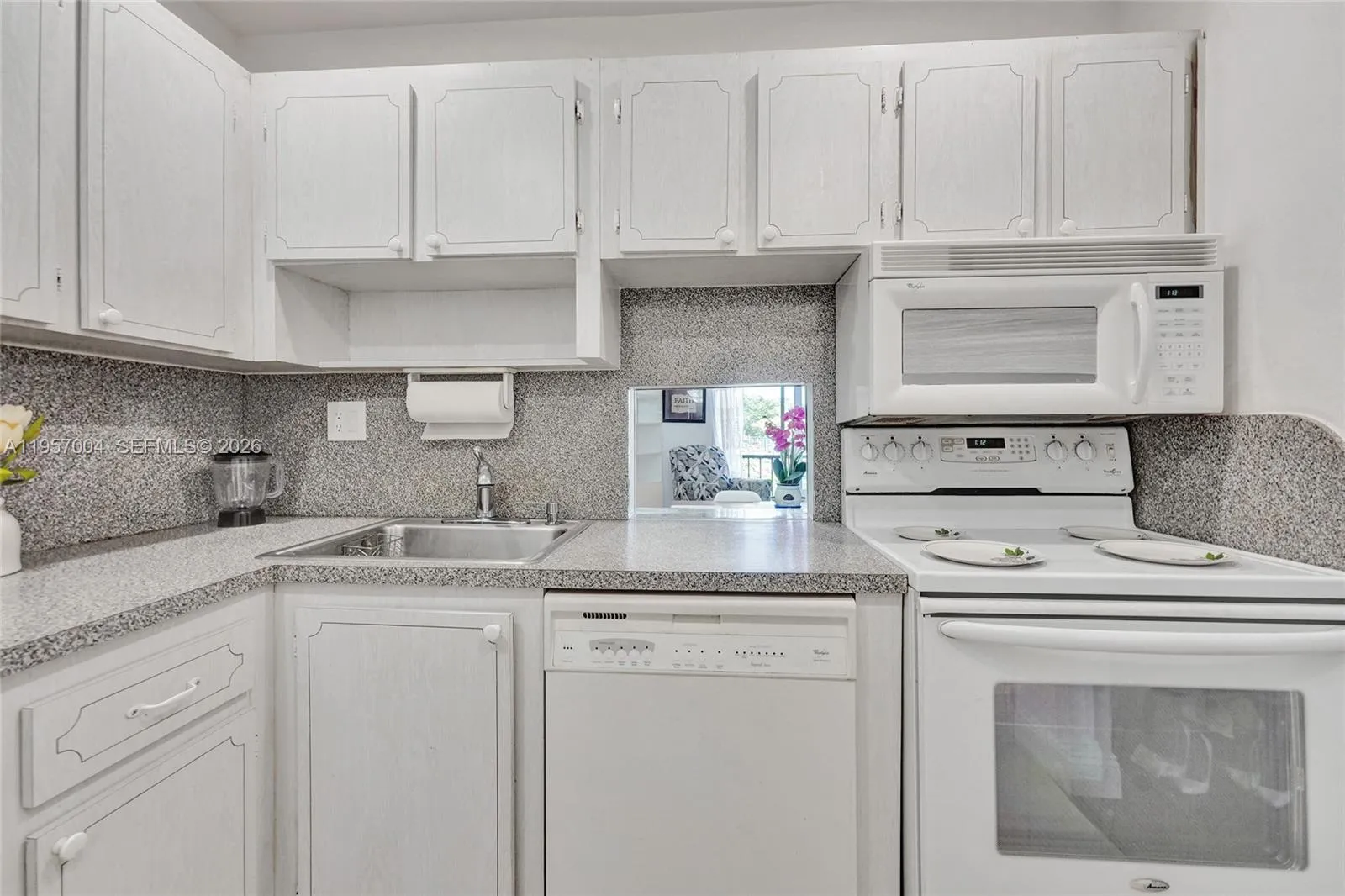 Spacious kitchen with sleek tile floors, offering a clean and modern aesthetic