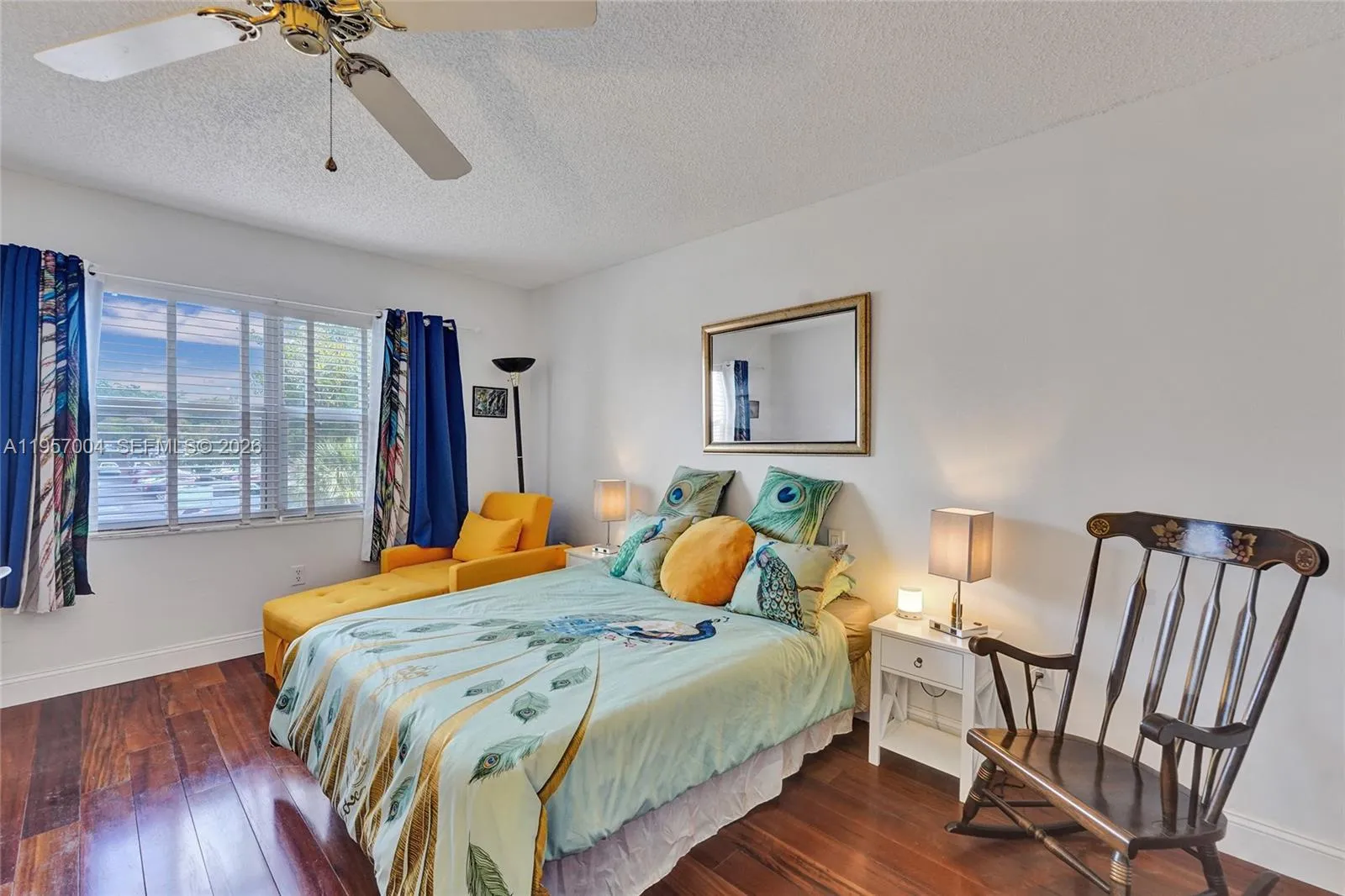 The spacious master bedroom is filled with natural light, creating a bright and airy atmosphere