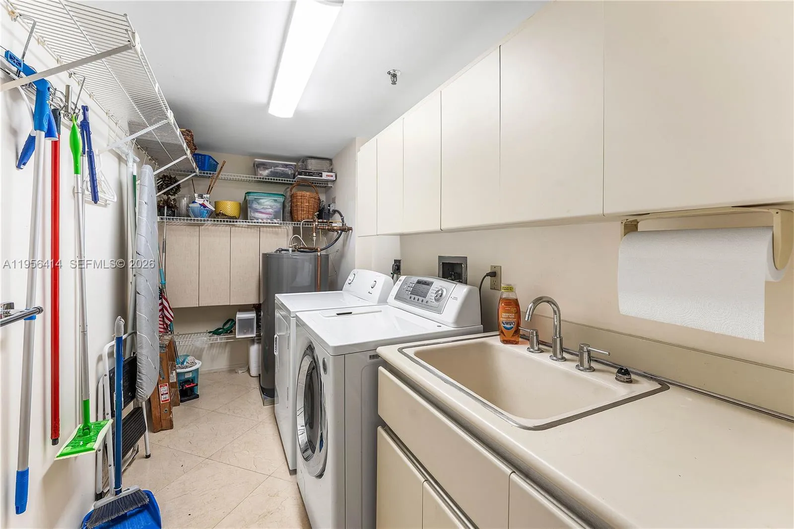 Large laundry room with sink and extra storage